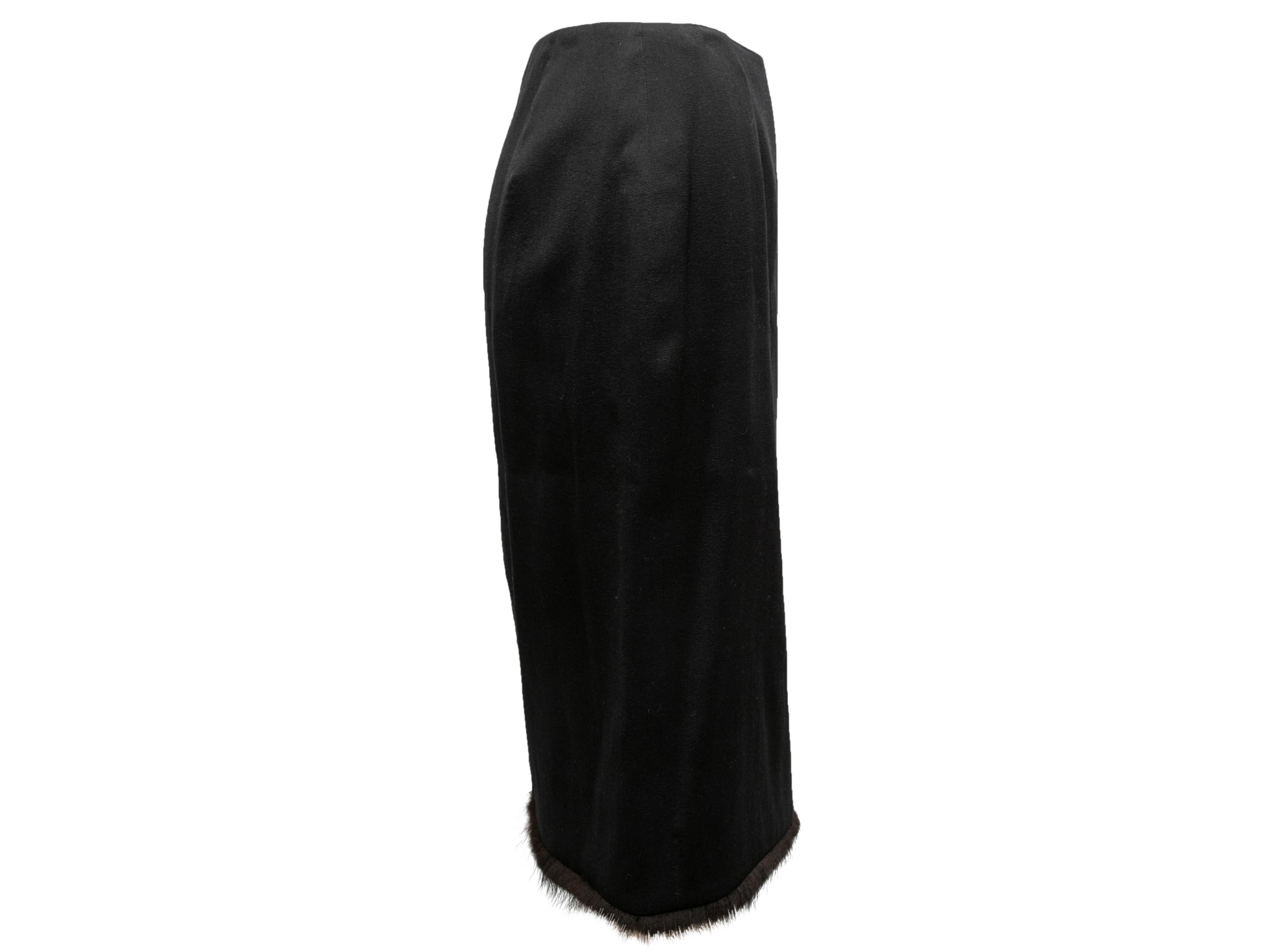 Vintage black knee-length skirt by Gianni Versace. Fur trim at hem. Zip closure. 27