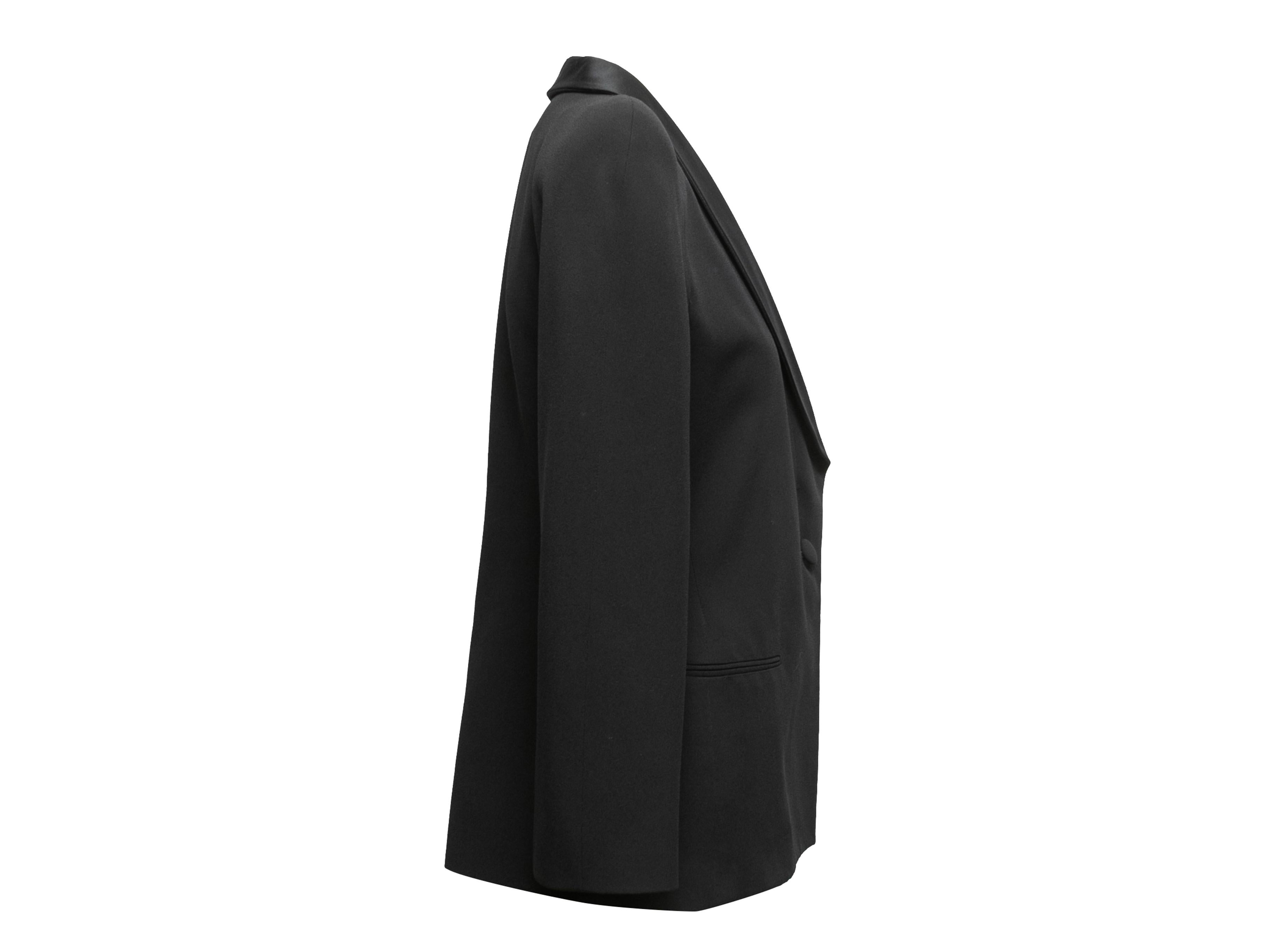 Vintage black tuxedo blazer by Giorgio Armani. Satin shawl collar. Structured shoulders. Dual welt pockets at hips. Front button closure. 40