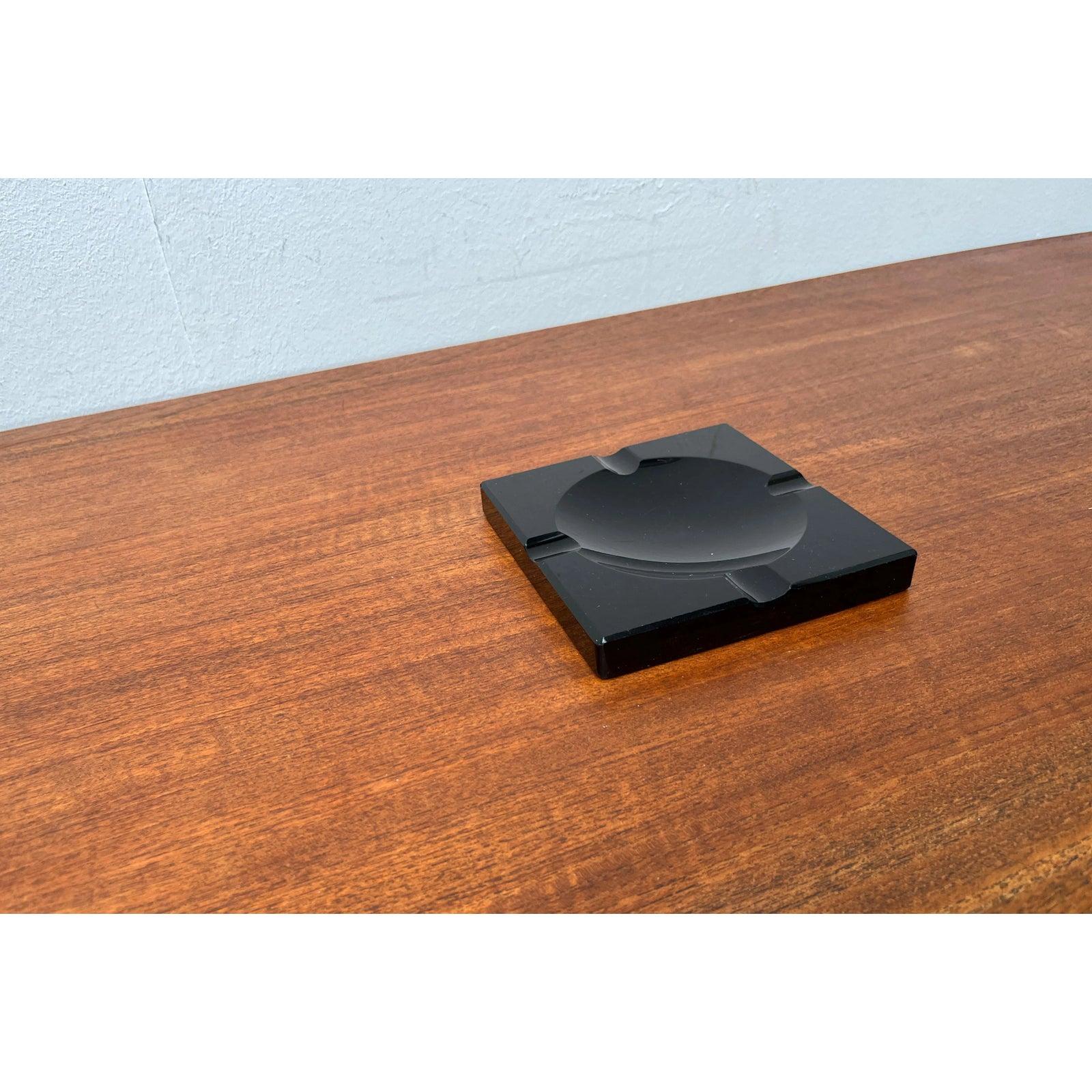 Vintage Black Glass Ashtray, 1980s, in Very Good conditions. Designed 1960 to 1969.

Additional information:
Materials: Glass
Color: Black
Styles: Postmodern
Item Type: Vintage, Antique or Pre-owned
Dimensions: 5.91ʺW × 5.91ʺD × 0.79ʺH
Condition: