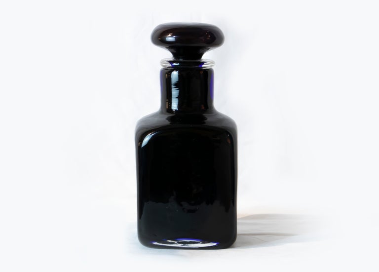 Black bottle is an original decorative object realized by Venini in the 1970s.

Elegant black Murano glass bottle with top. Marked under the base.

In very good conditions.

Produced by Venini

Paolo Venini (1895-1959) emerged as one of the