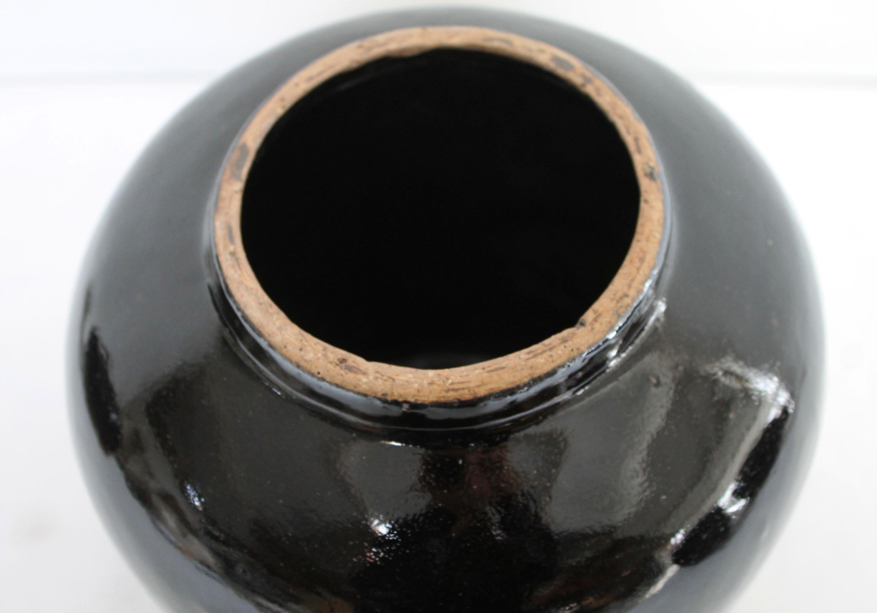 Beautifully glazed and rich in character, this vintage glazed oil pot adds just the right amount of texture + warmth where you need it. Stunning black glazed finish with warm terracotta accents.

Approximate Sizing: 8.5