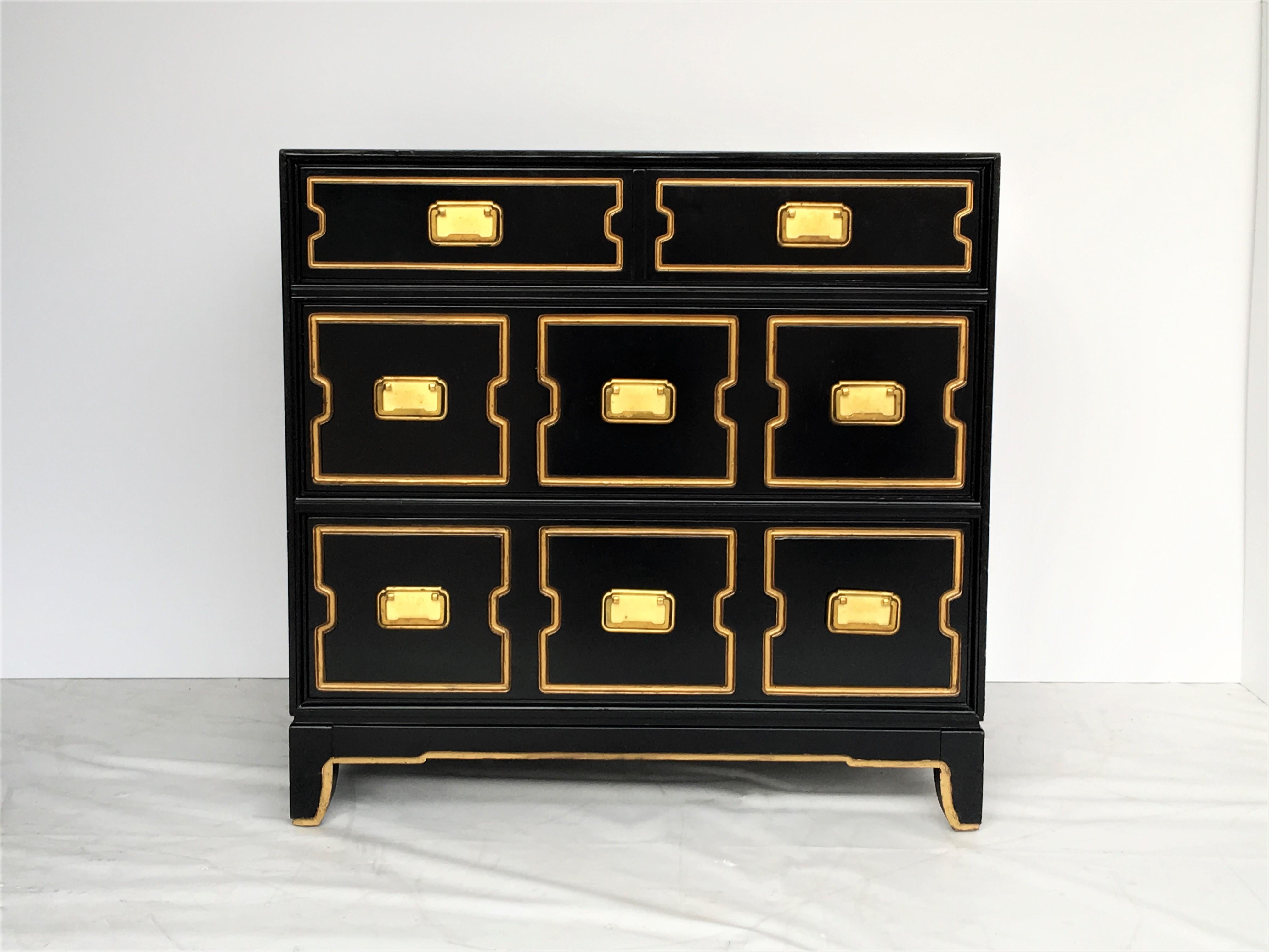 This chest has three drawers with brass Campaign style hardware and incised design highlighted in gold. Professionally lacquered in black.