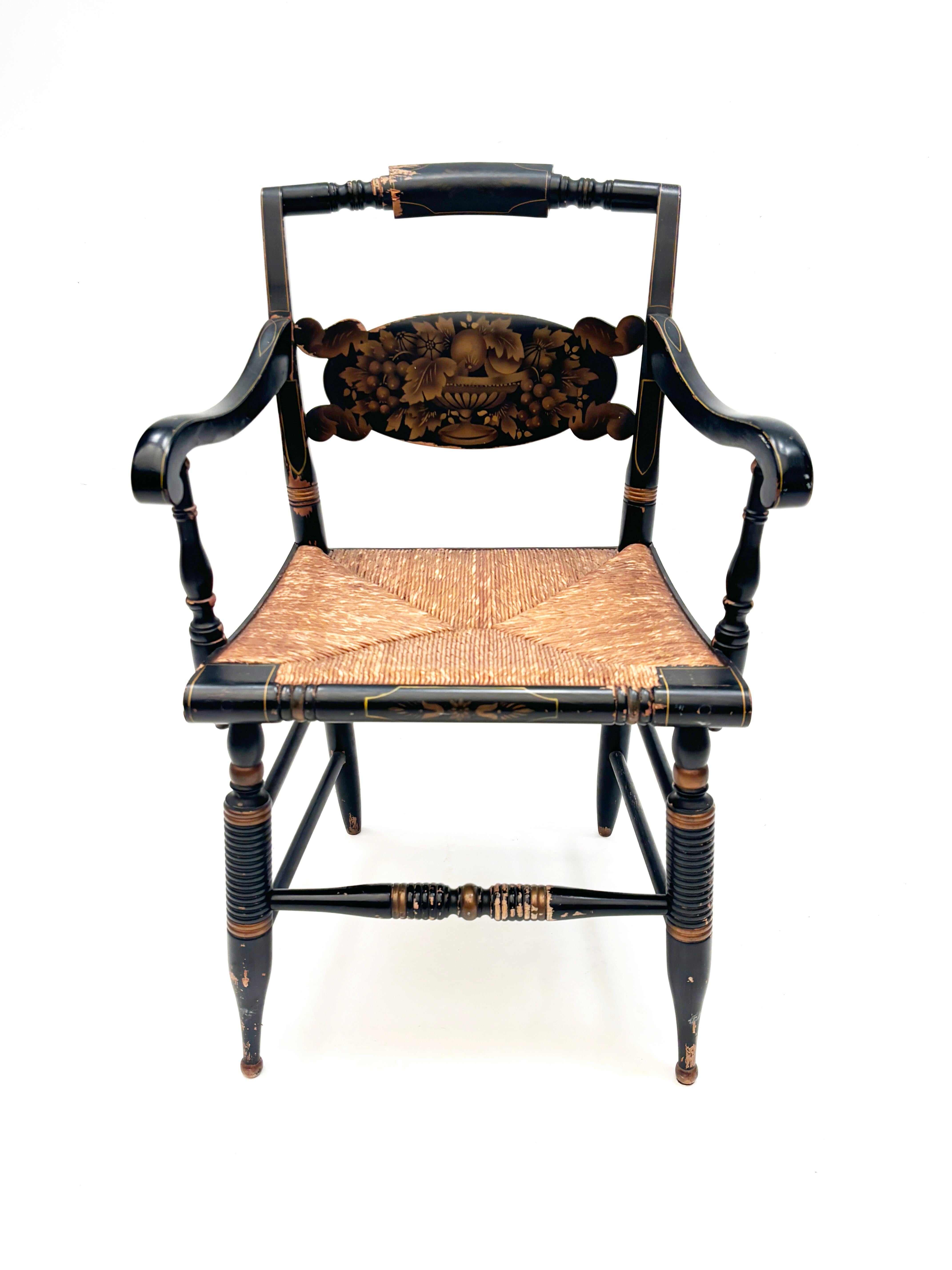 These L. Hitchcocks chairs are as one would expect coming from Hitchcock, simply splendid. With their signature black painted finish and gold stencil work overall, the age, patina and wear add wonderful character to this grouping. The four piece set