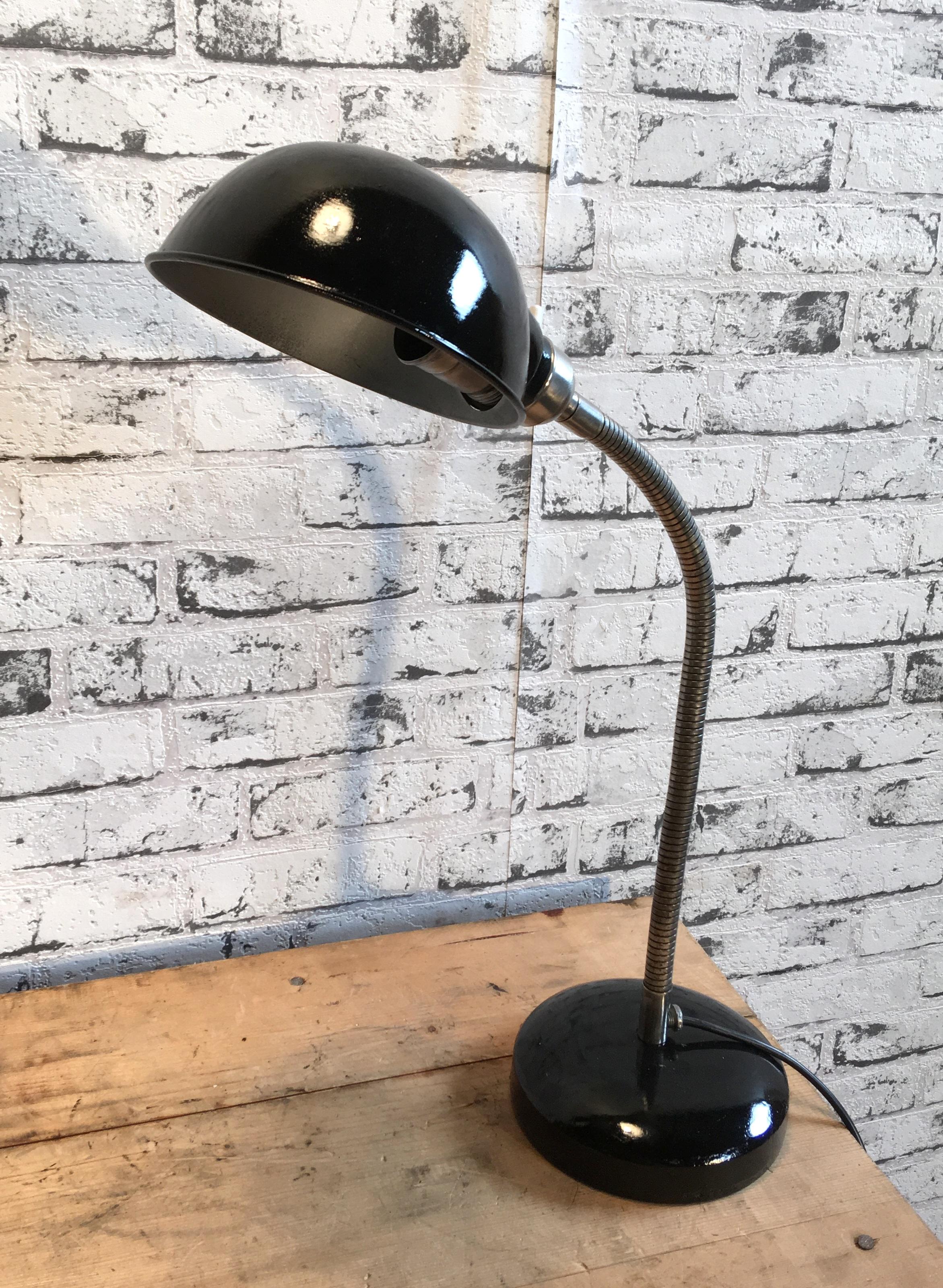 Industrial adjustable table lamp from 1950s. It features black aluminium shade, iron base and chrome-plated gooseneck. Original socket for E 27 bulbs with ceramic rotary switch, new wire. Good vintage condition. Measures: Shade diameter 16cm.