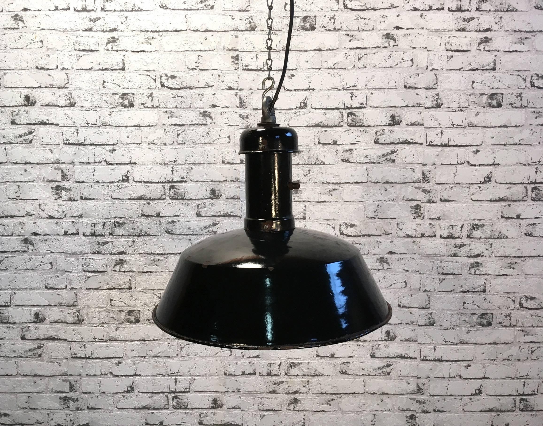 Pendant lamp from former Czechoslovakia, previously used in a factories.
Made from enamelled metal. Black outside, white interior. Interesting top.
New porcelain socket for  E 27 lightbulbs and wire. Good vintage condition.
Weight: 3 kg.
