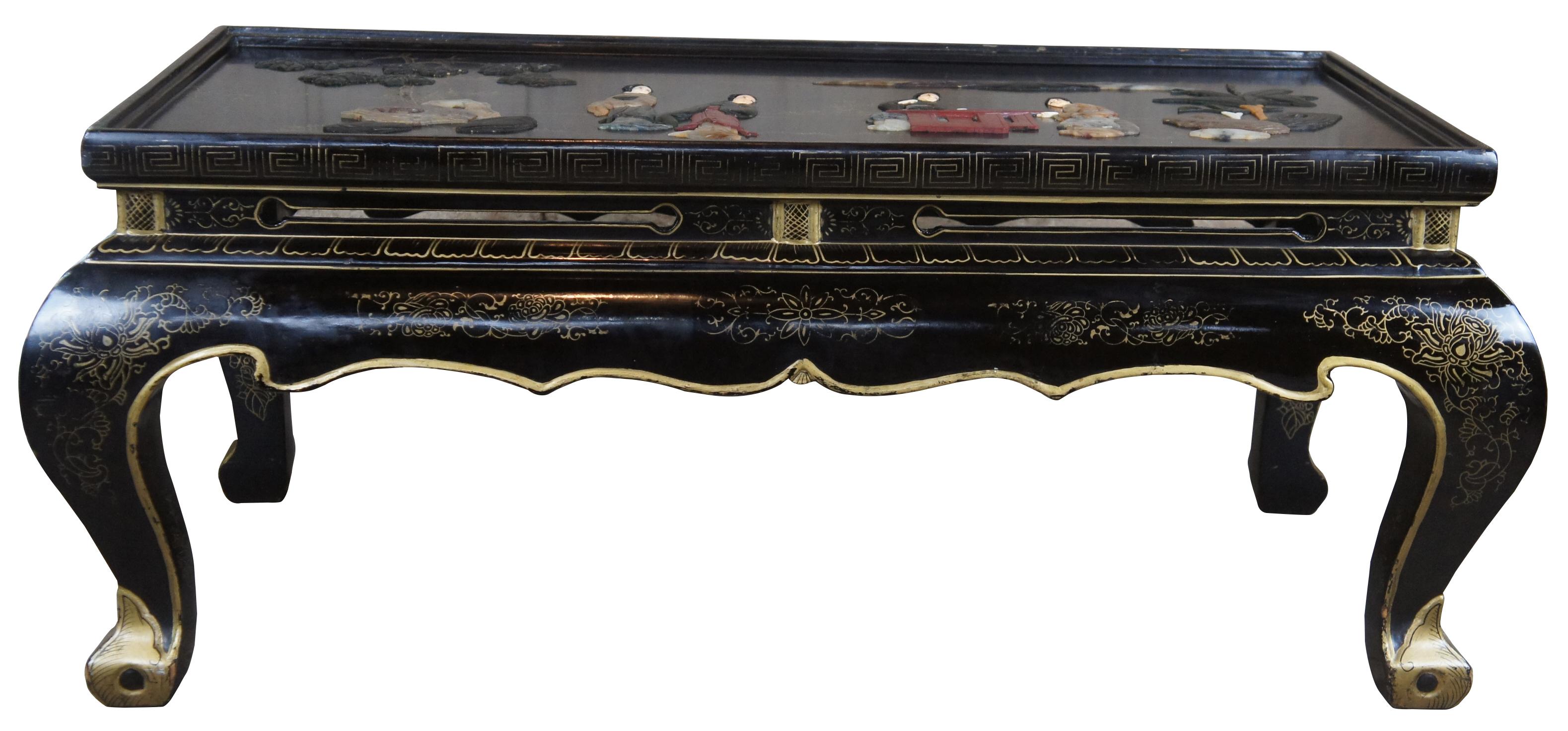 Vintage Chinese chinoiserie tea / coffee table. Carved and finished in black with soapstone geisha scenes and gold accents with greek key and florals with serpentine base and cabriole legs.
 