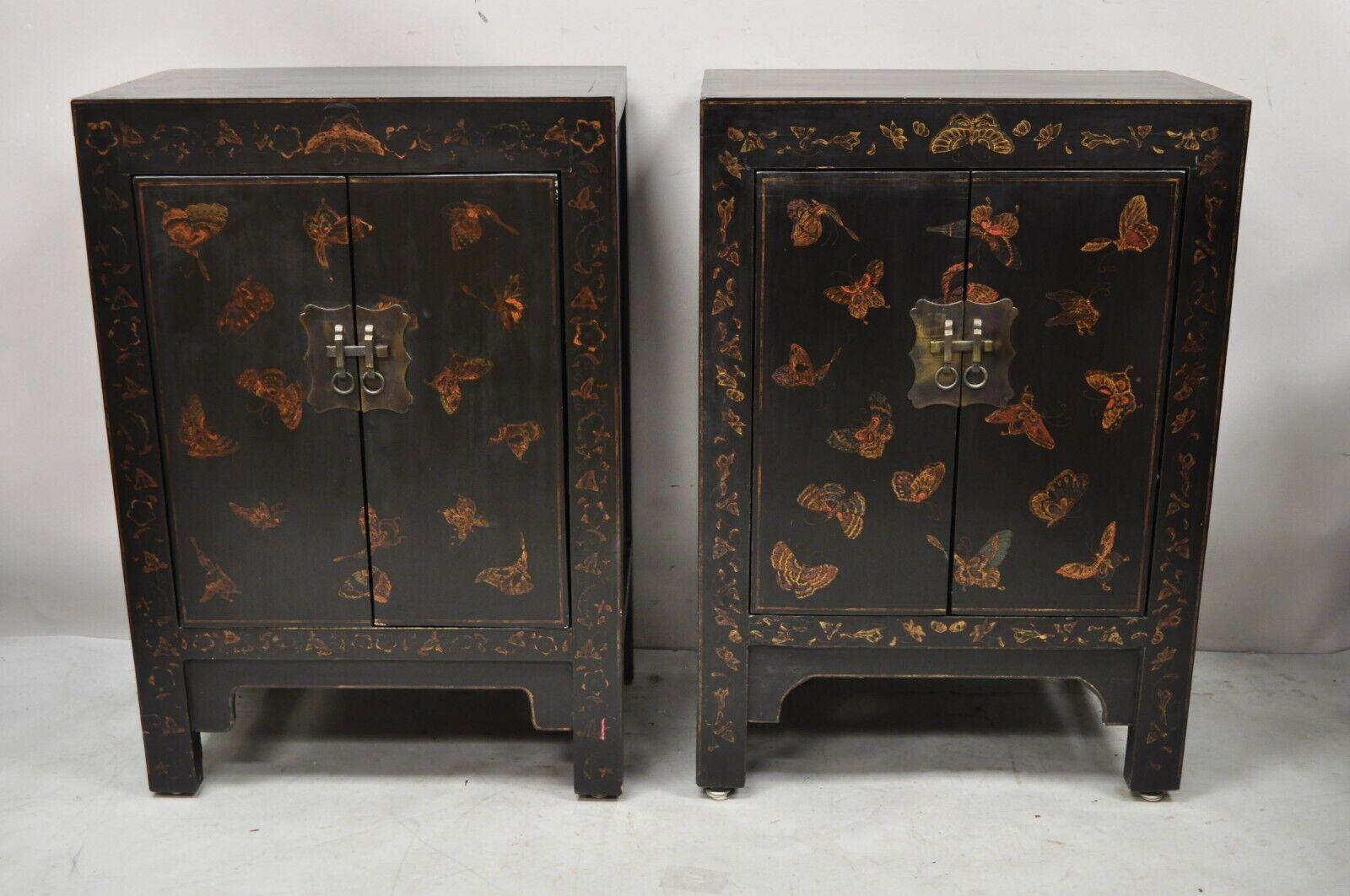 Vintage black lacquer hand painted butterfly chinese oriental cabinets - a pair. Item features hand painted butterflies, black lacquer finish, 2 swing doors, solid brass hardware, great style and form. Circa mid to late 20th century. Measurements: