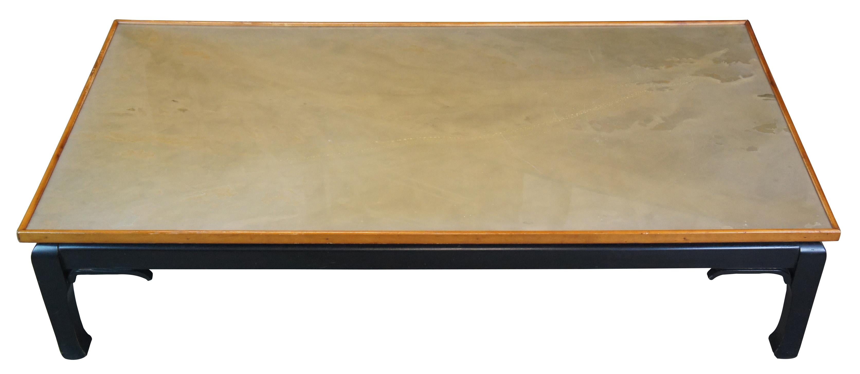 A beautiful low coffee table in James Mont or Ming style. Features a black lacquer base with light faux green marbled top with a light maple frame.  Measure: 60