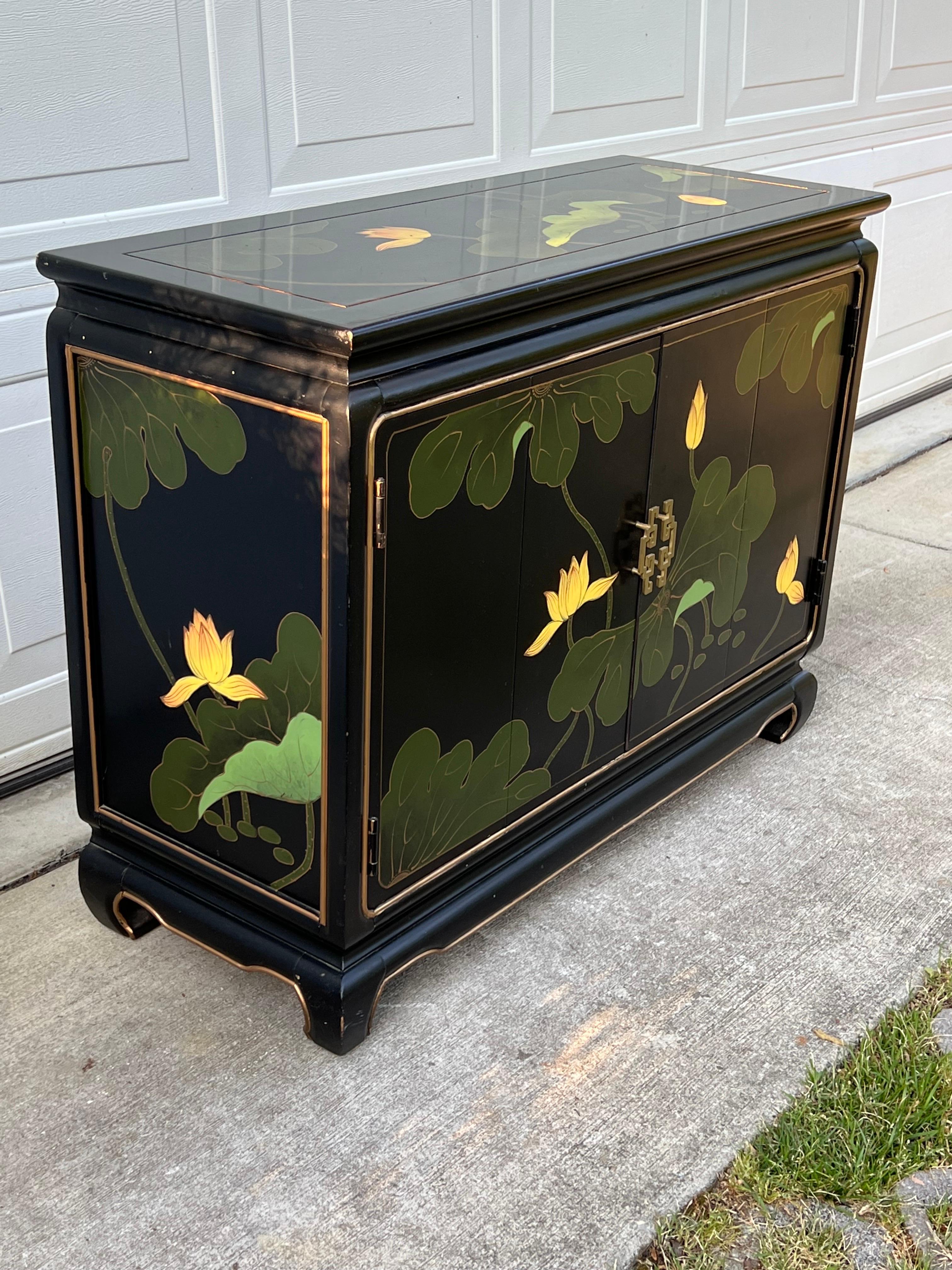 Stunning Black Lacquered Buffet/cabinet with a single adjustable shelf inside, with and amazing hand painted design of flora in rich colors accented in gold 
A rare piece that will elevate any room in your home!.