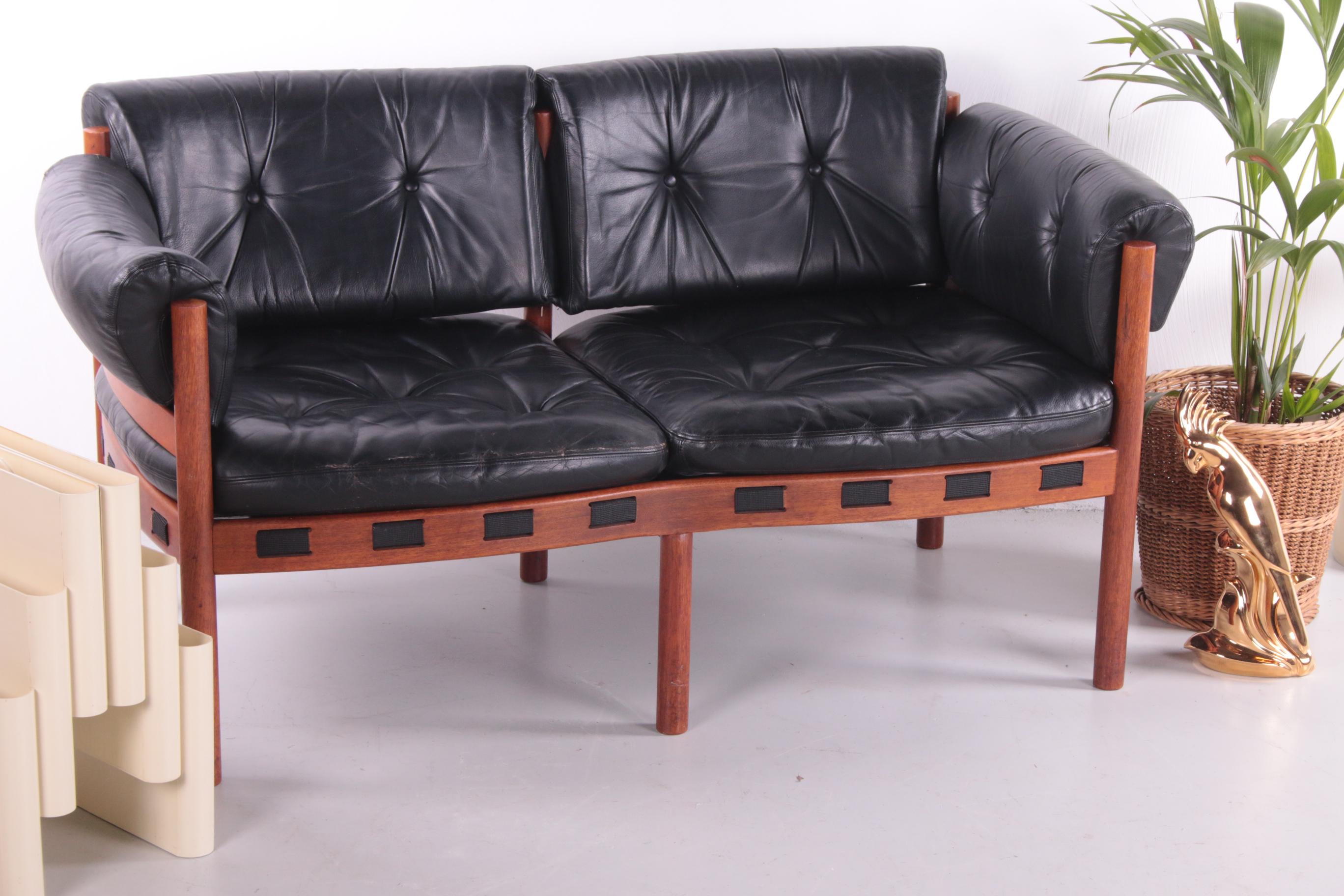A beautiful vintage designer sofa from the seventies.

Designed by Swedish designer Sven Ellekaer for Coja. His signature mid-century Scandinavian style is easily recognized in this beautiful piece of furniture.

The sofa has a black leather