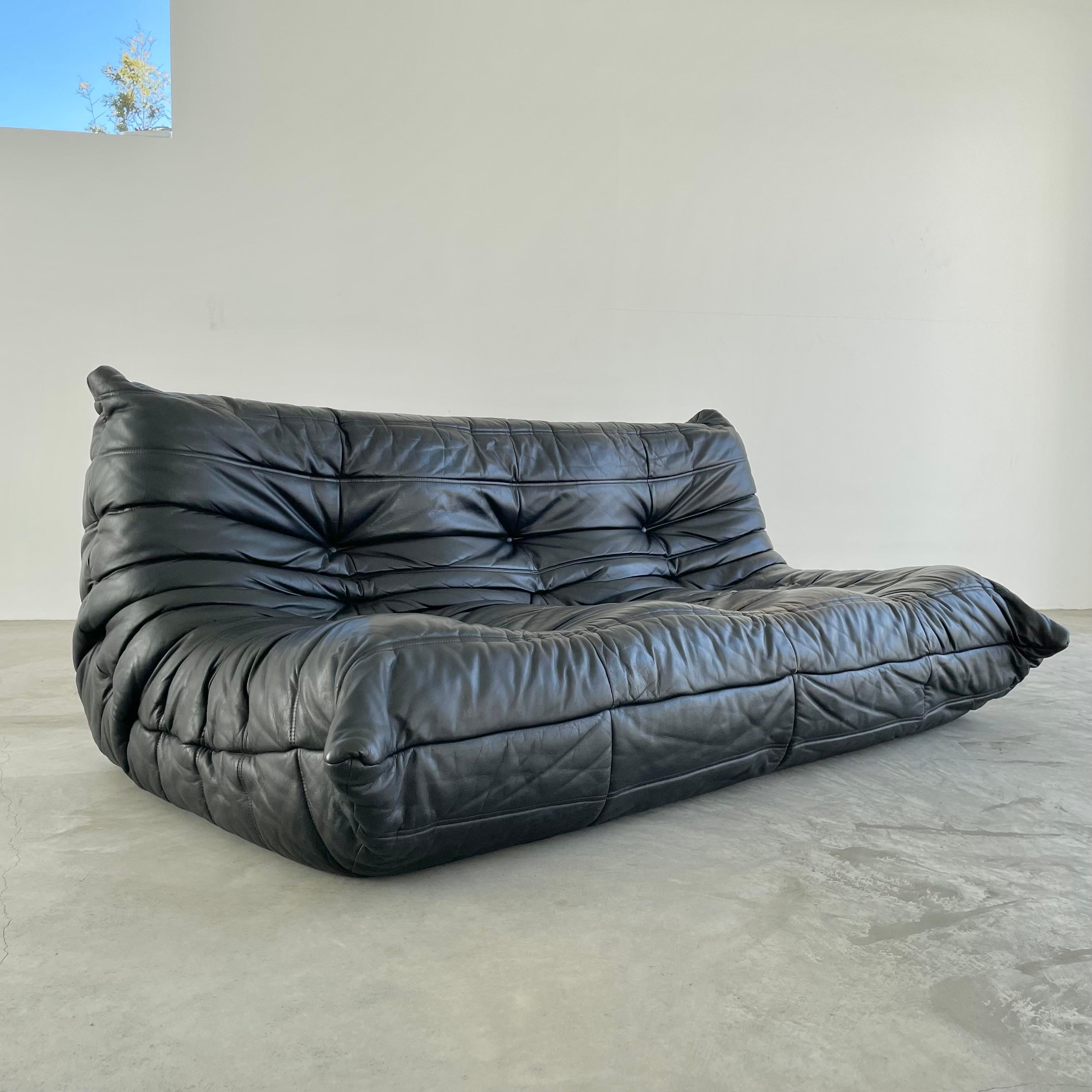 Classic French Togo sofa by Michel Ducaroy for luxury brand Ligne Roset. Originally designed in the 1970s the iconic togo sofa is now a design classic. This sofa comes in its original vintage black leather which, unlike other vintage leathers that