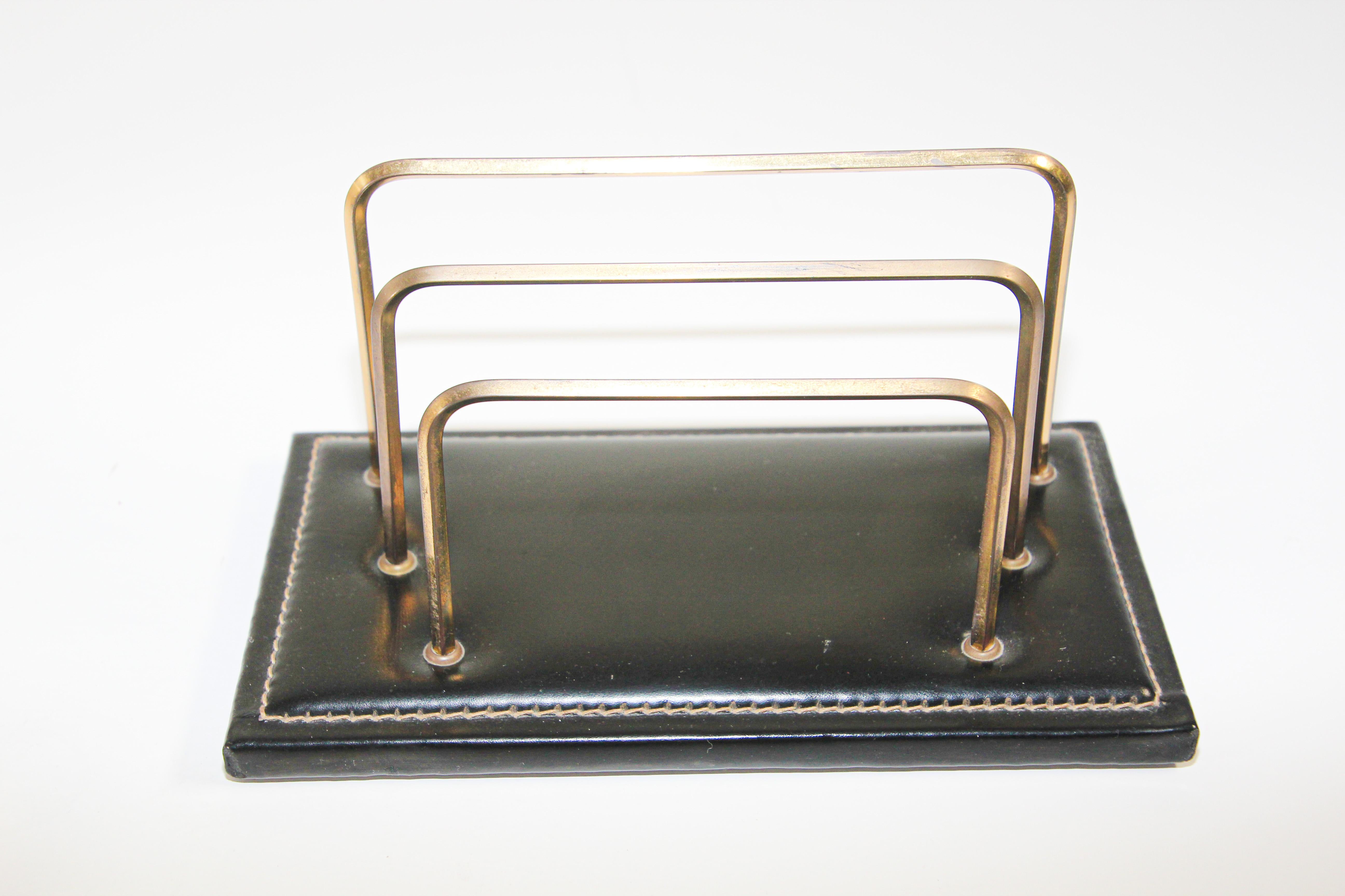Jacques Adnet Art Deco Black Leather Saddle Stitching Brass Desk Set 1950 France.
Adnet Art Deco style desk set comprising of a black leather and brass letter desk holder, rack, picture frame and a leather note pad with original paper refill and