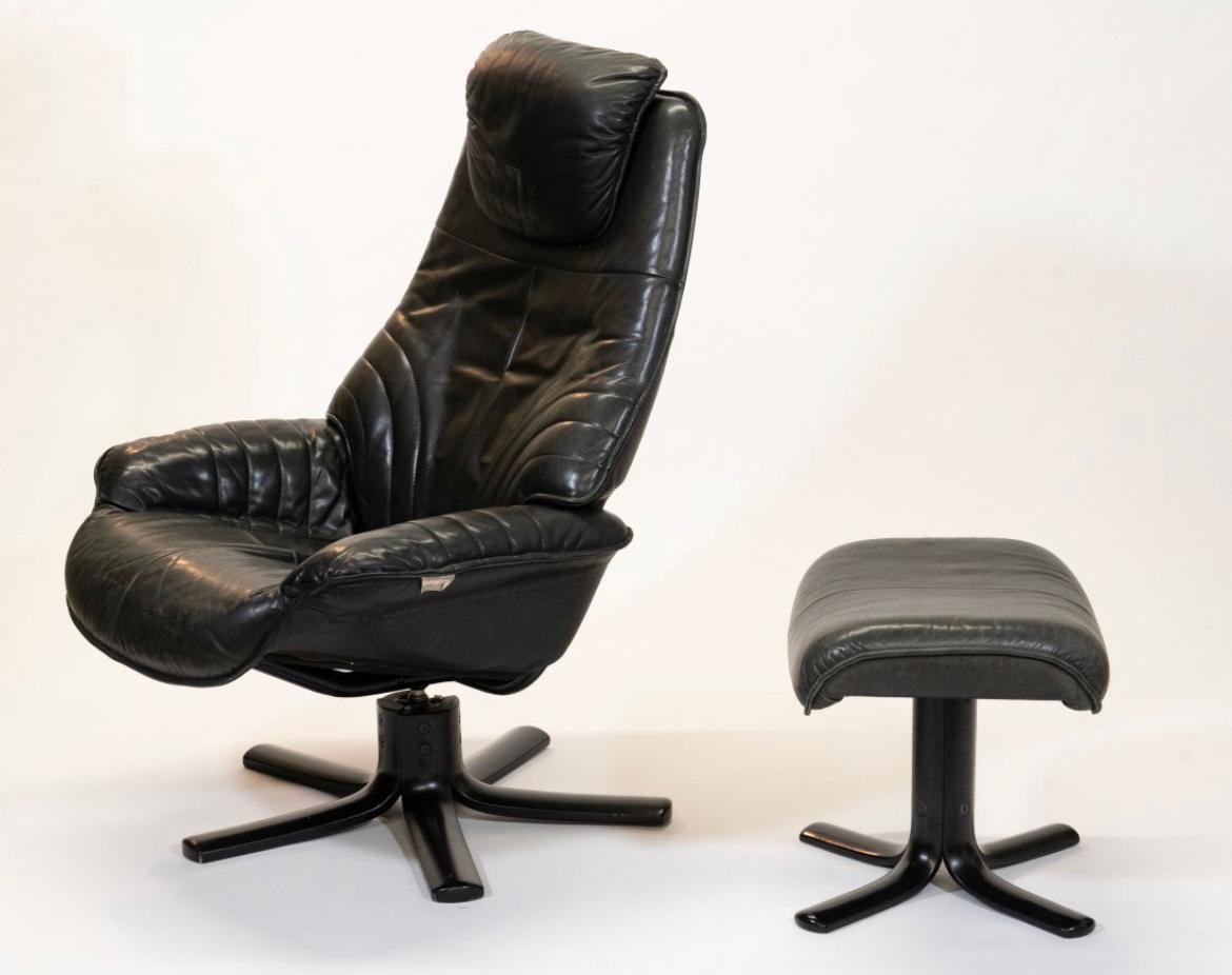 Vintage mid century Black leather lounge chair with ottoman by Hjellegjerde Made in Norway. Hjellejerde black leather lounge chair and matching ottoman with black lacquer base. Has full tilt back option Extremely comfortable chair. Chair has the