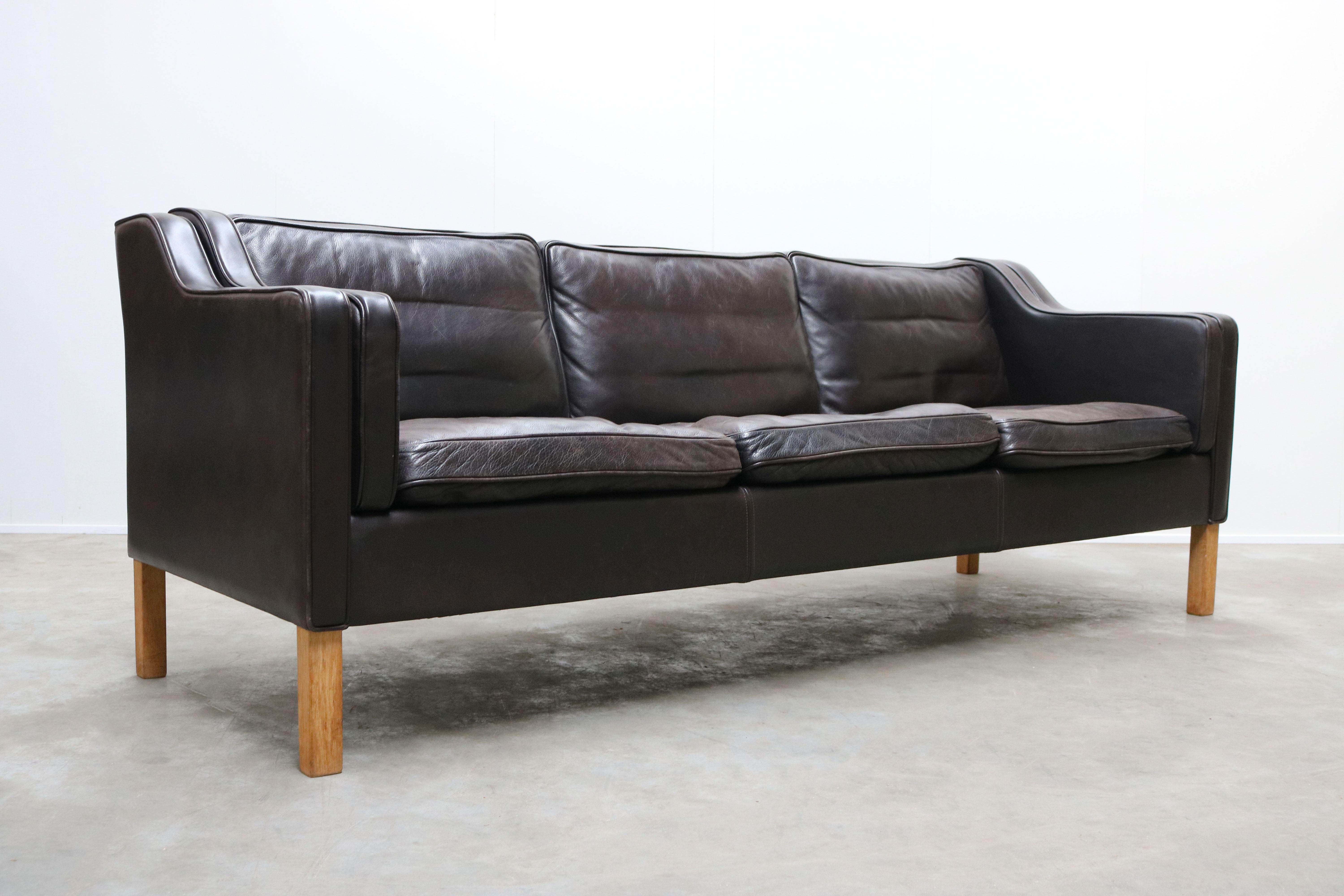 Beautiful vintage example of the classic three-seat sofa designed by Børge Mogensen for Fredericia, model 2213. Sides, back and loose cushions upholstered with black patinated leather. Solid oak legs. Seat cushions with foam, side and back cushions