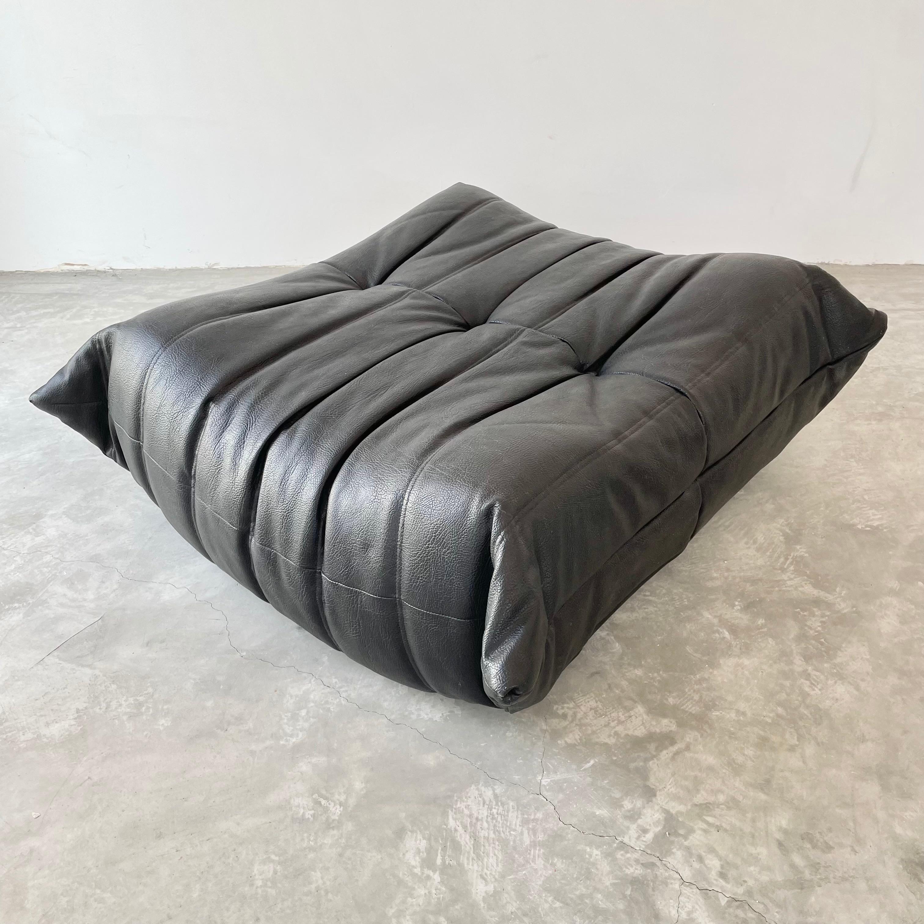 Classic French Togo ottoman by Michel Ducaroy for luxury brand Ligne Roset. Originally designed in the 1970s the iconic togo sofa is now a design classic. This ottoman comes in its original vintage pebbled black leather.

Timeless comfort and