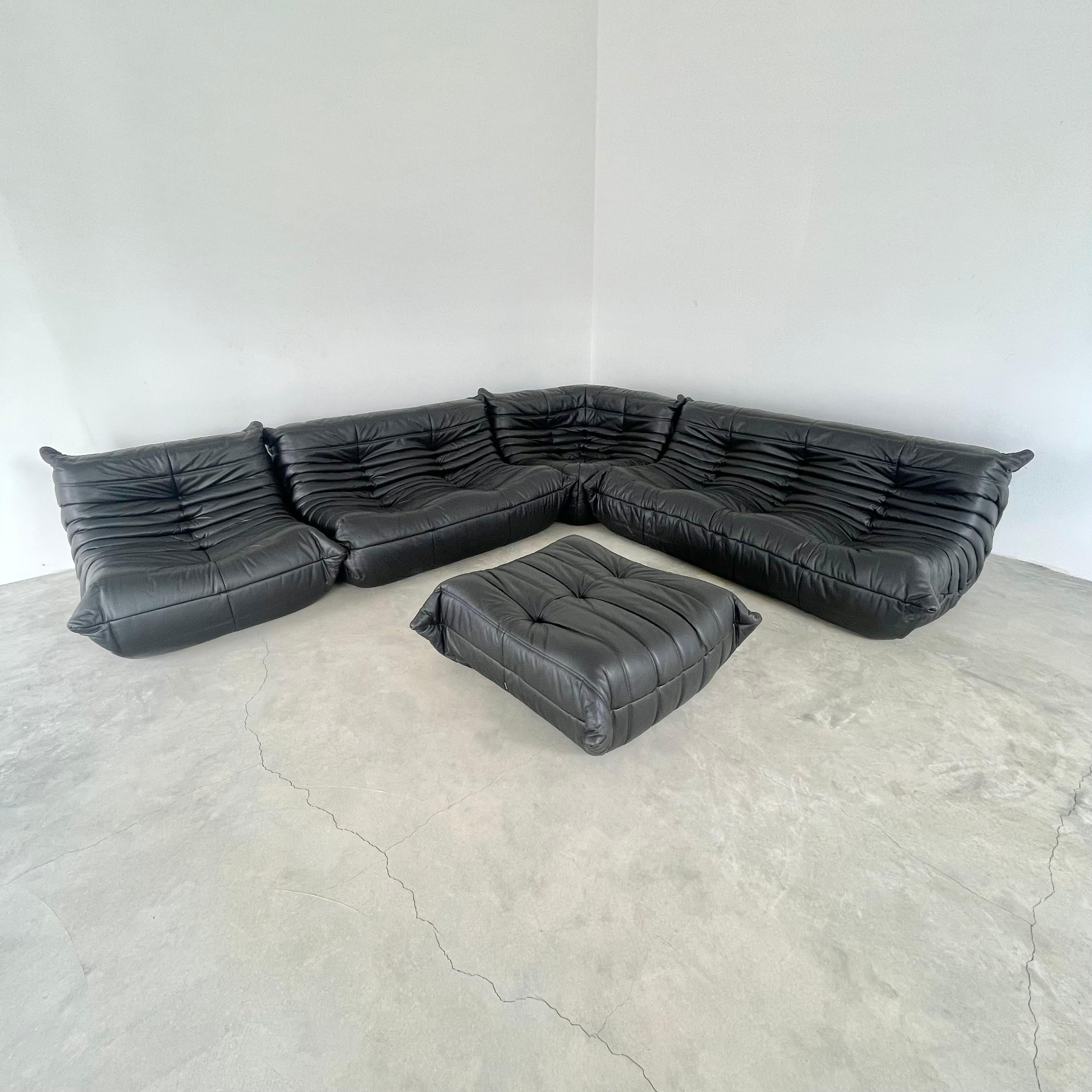 Classic French Togo set by Michel Ducaroy for luxury brand Ligne Roset. Originally designed in the 1970s the iconic togo sofa is now a design classic. This set comes in its original black leather.

Timeless comfort and style make this monumental