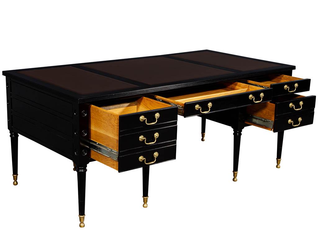 Vintage black leather top desk by Councill. Rare unmatched quality desk with original brass hardware, finished in a hand rubbed ebony lacquer with three leather panel inserts.

Price includes complimentary curb side delivery to the continental USA.