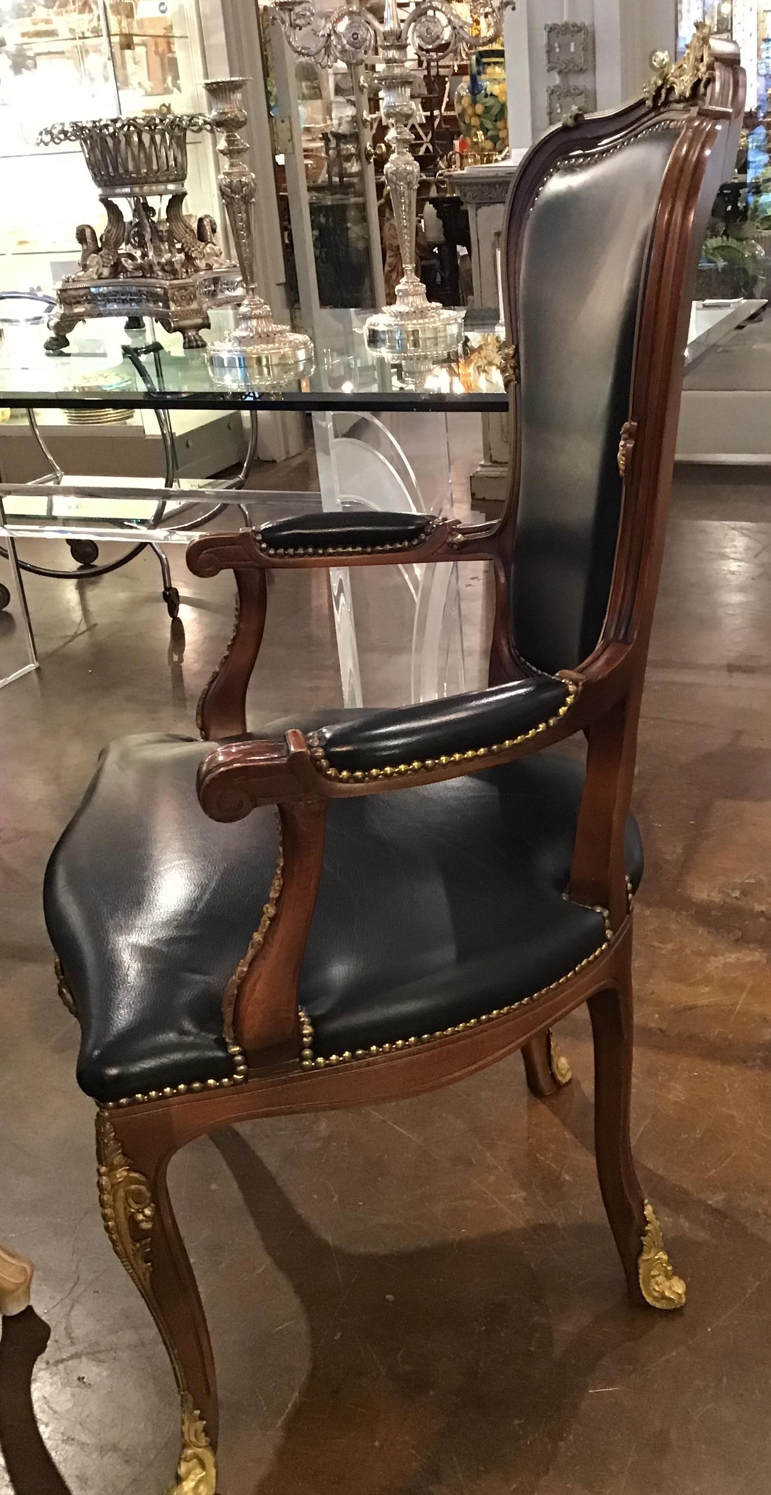 Large vintage armchair in Louis XV style with black leather upholstery and bronze mounts. Chair is sturdy and heavy, made in generous size. Nice and stylish piece, would work great for office or library.

Very good vintage condition, wear natural to