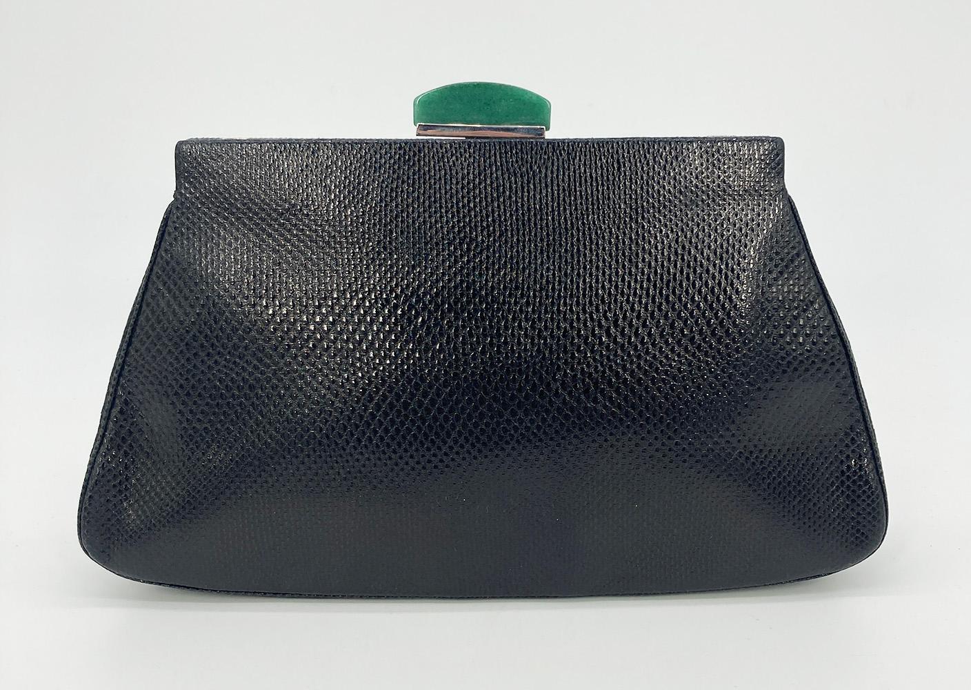 Vintage Judith Leiber Black Lizard Green Enamel Top Clutch in very good condition. Black lizard leather trimmed with silver hardware and green enamel detail along top edge. Lift latch jade closure opens to a black satin interior with one slit and