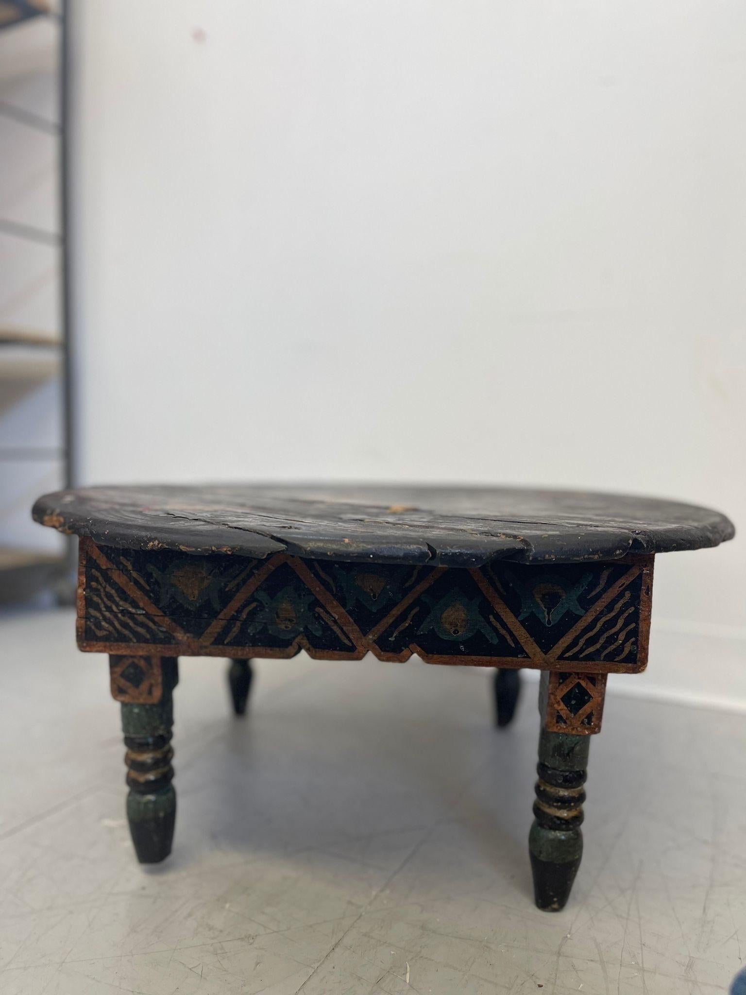 Table with Unique Illustrations of Human and Animals.
Notches on the Legs. Splitting and Vintage Condition Consistent with Age.

Dimensions. 23 Diameter ; 11 H