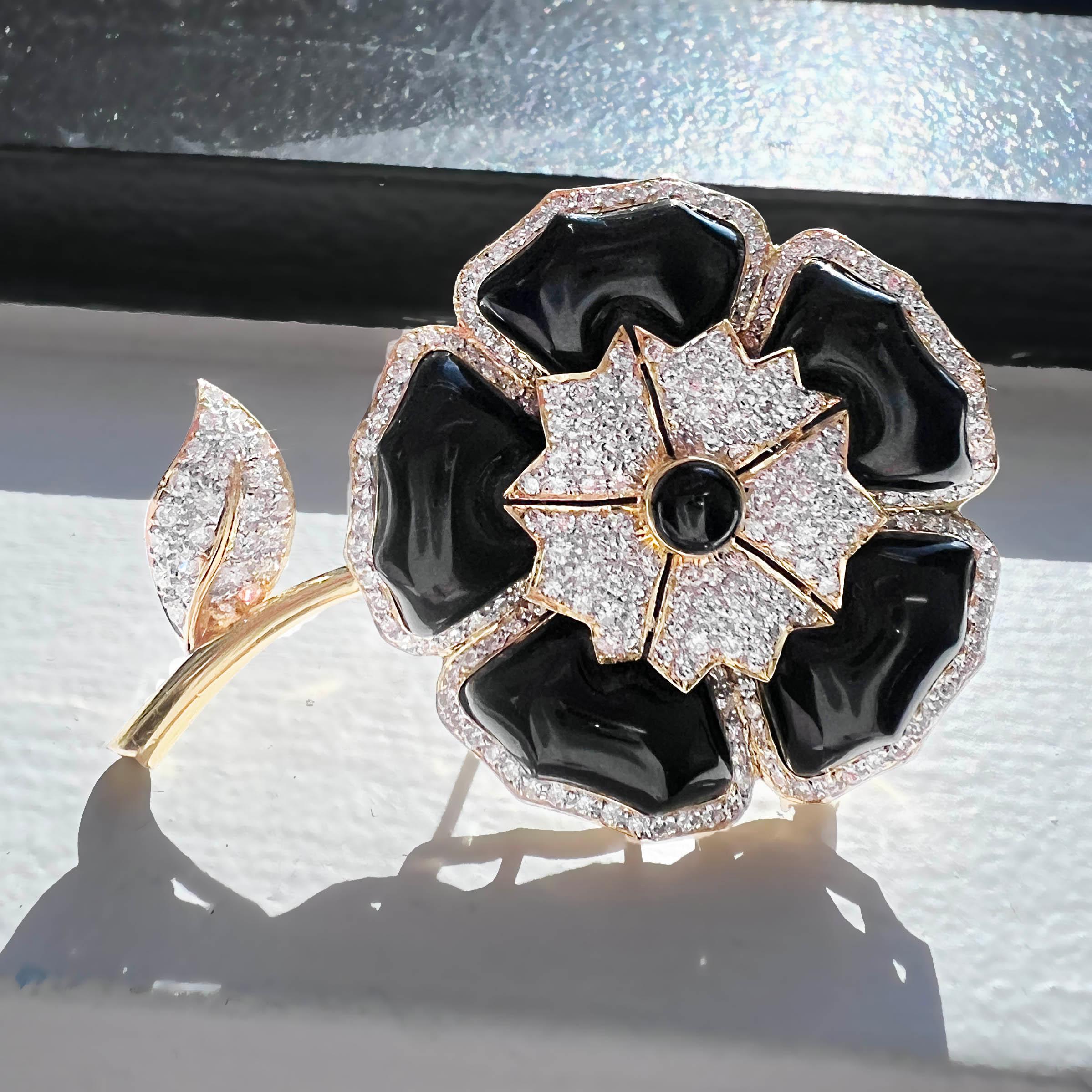 This exquisite black onyx and diamond flower brooch is a striking statement piece that combines timeless elegance with exceptional craftsmanship. Featuring 235 dazzling diamonds totaling 1.75 carats, this brooch sparkles brilliantly against the deep