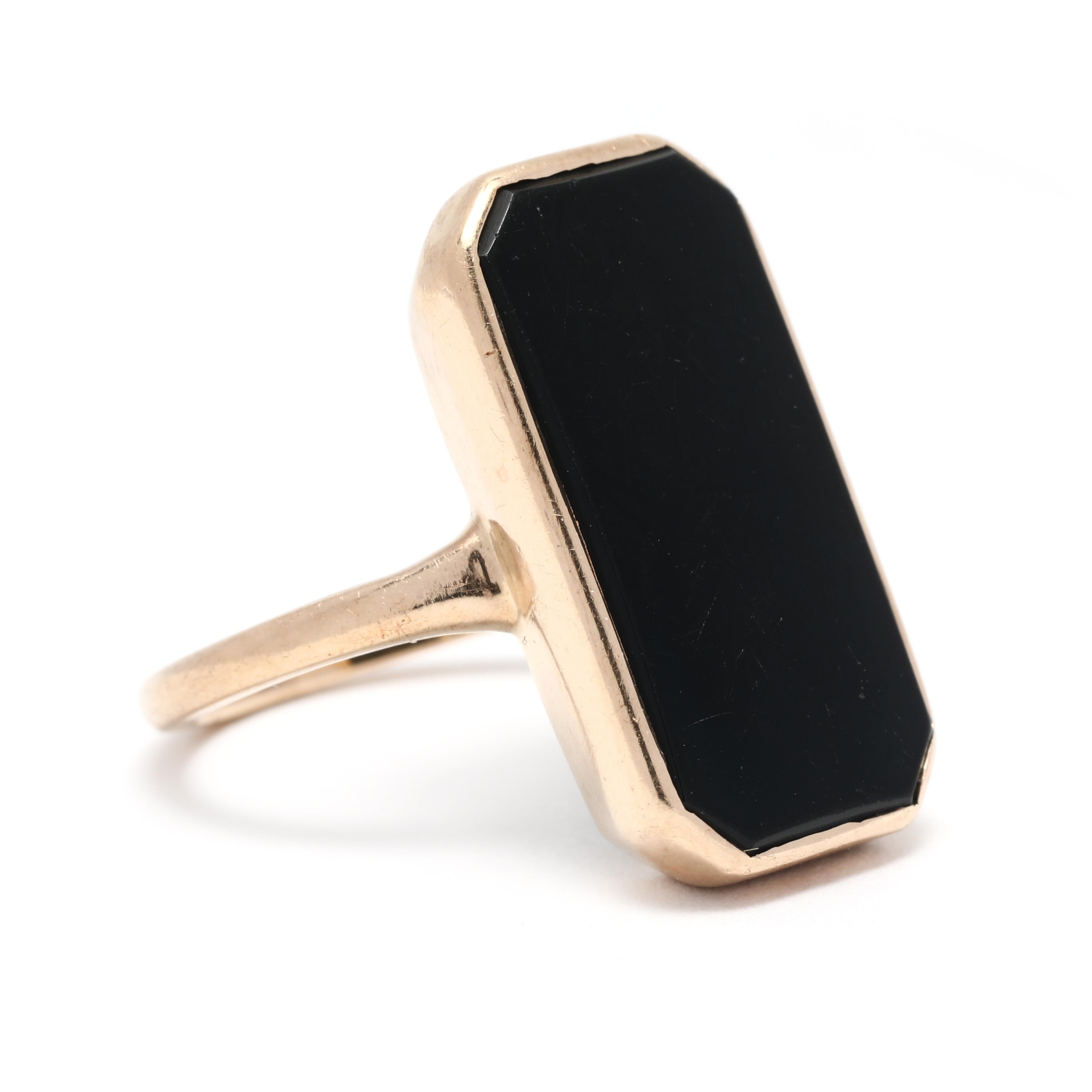 This vintage black onyx rectangle cocktail ring is truly a unique and one-of-a-kind piece. The black onyx gemstone is set in a 14k yellow gold setting, making it a durable and precious piece. The ring is a size 5 and is perfect for everyday wear.