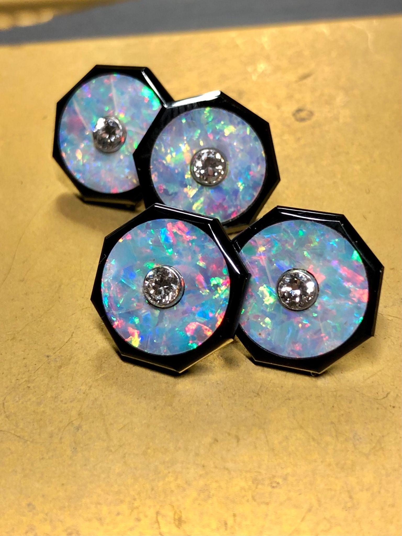 Beautiful cufflinks are a rarity, but these are truly exceptional. Backed in 18K gold, the octagonal onyx sections are inlayed with fiery pieces of natural black opal exhibiting flashes of red, orange, green and blue. Centered in each piece of opal