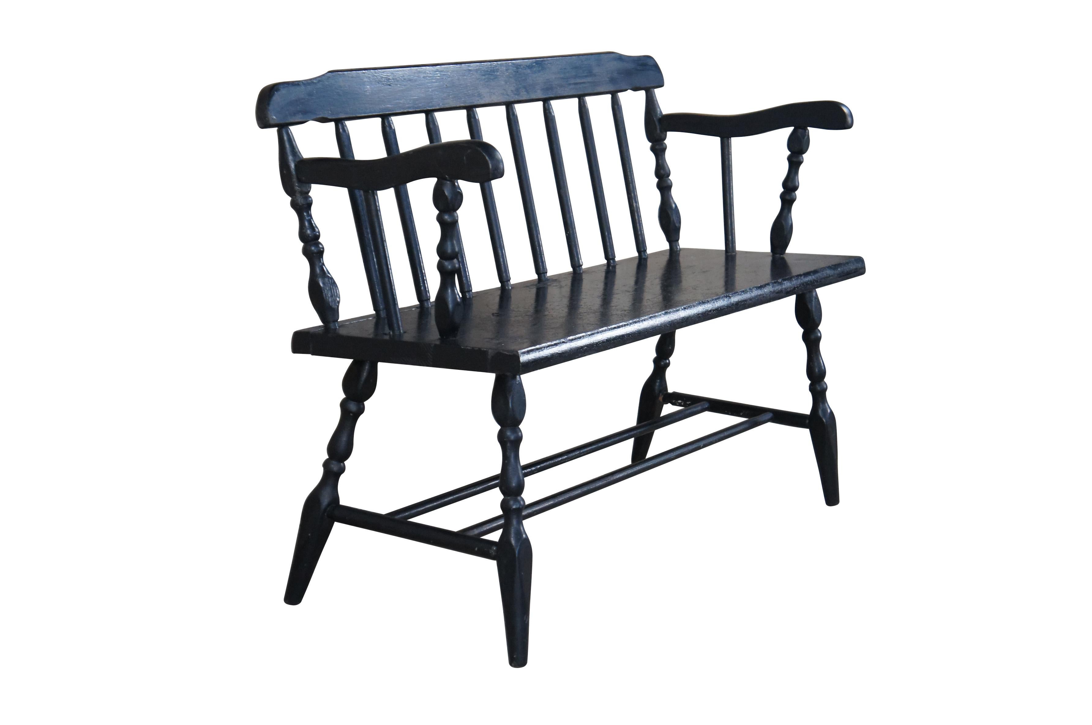 Vintage Windsor spindle back bench featuring painted black finish, turned posts and high arms.

Dimensions:
19