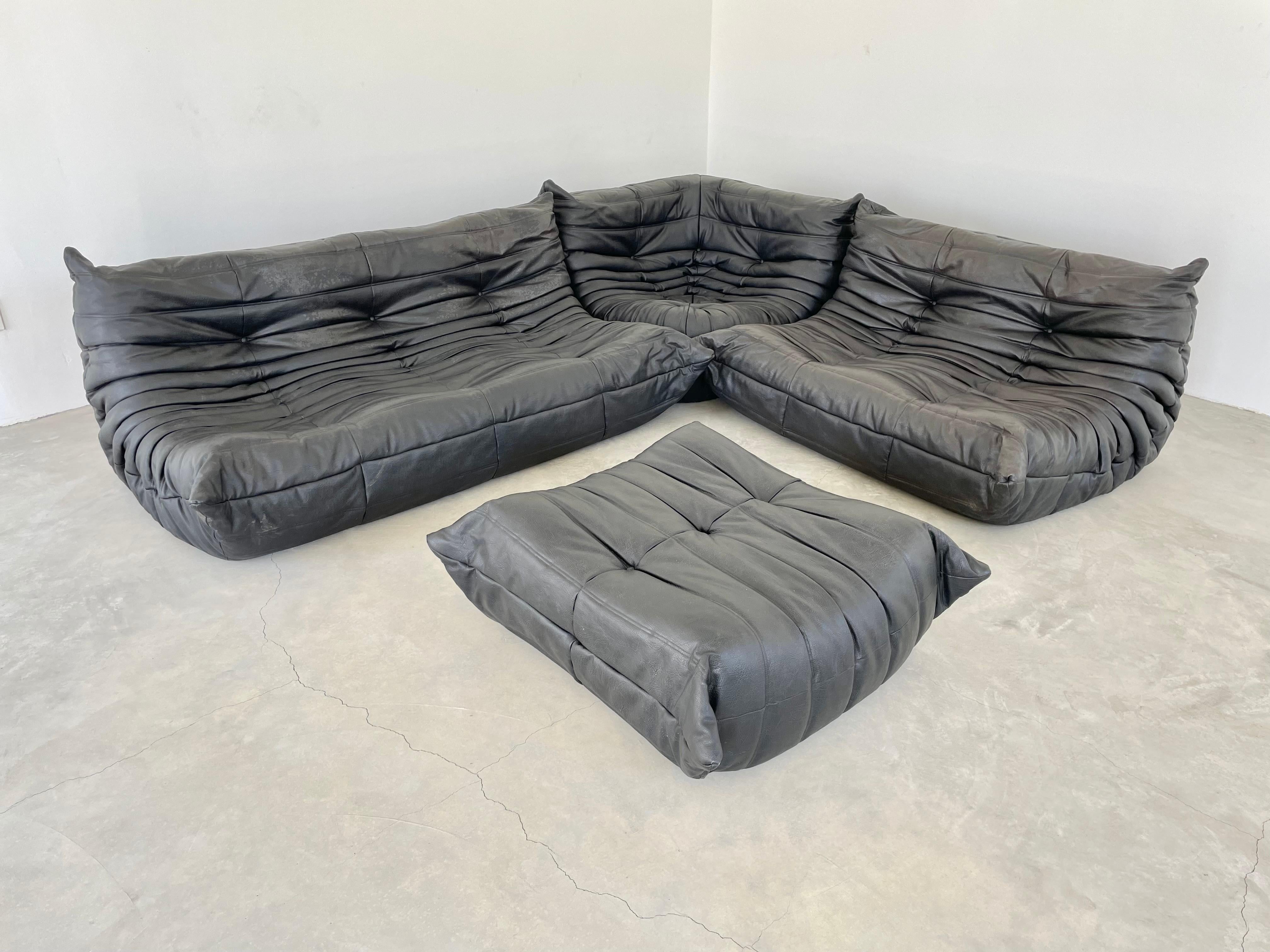 Classic French Togo set by Michel Ducaroy for luxury brand Ligne Roset. Originally designed in the 1970s the iconic togo sofa is now a design classic. This set comes in its original vintage pebbled black leather.

Timeless comfort and style make