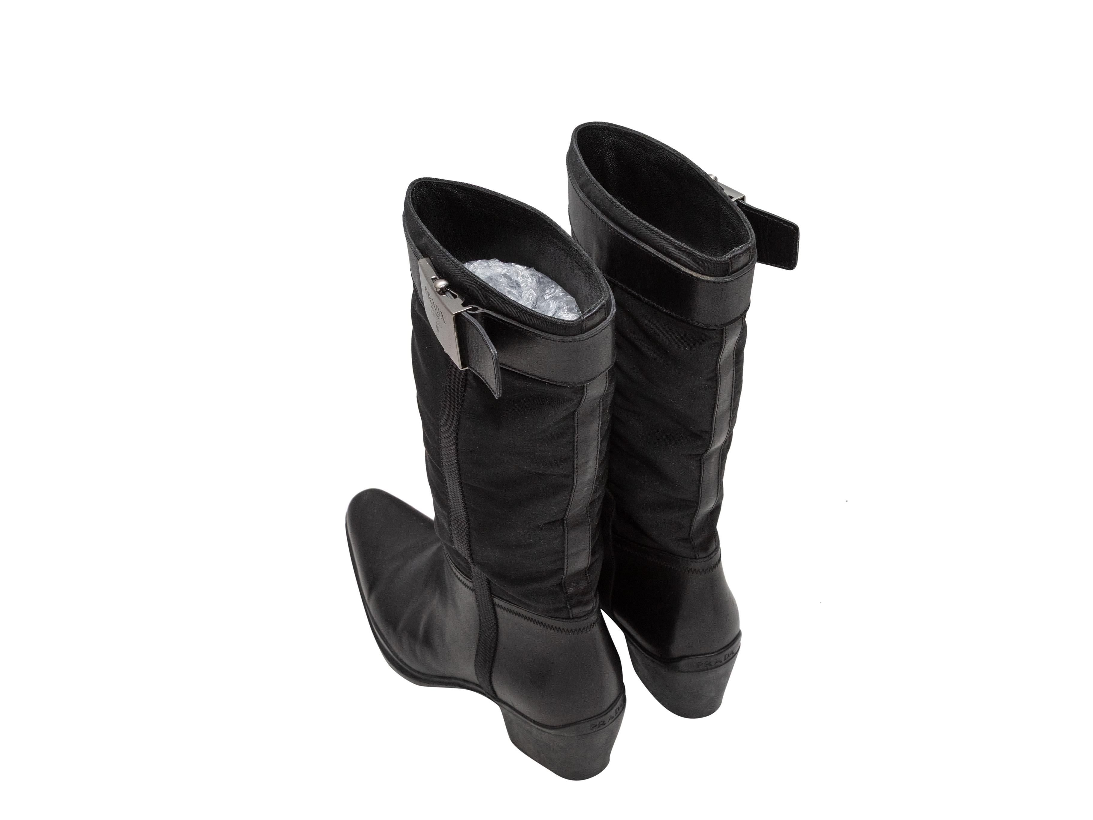 Vintage black leather and nylon western boots by Prada. Circa 90s. Block heels. Silver-tone buckle accents at outer sides. 10.75