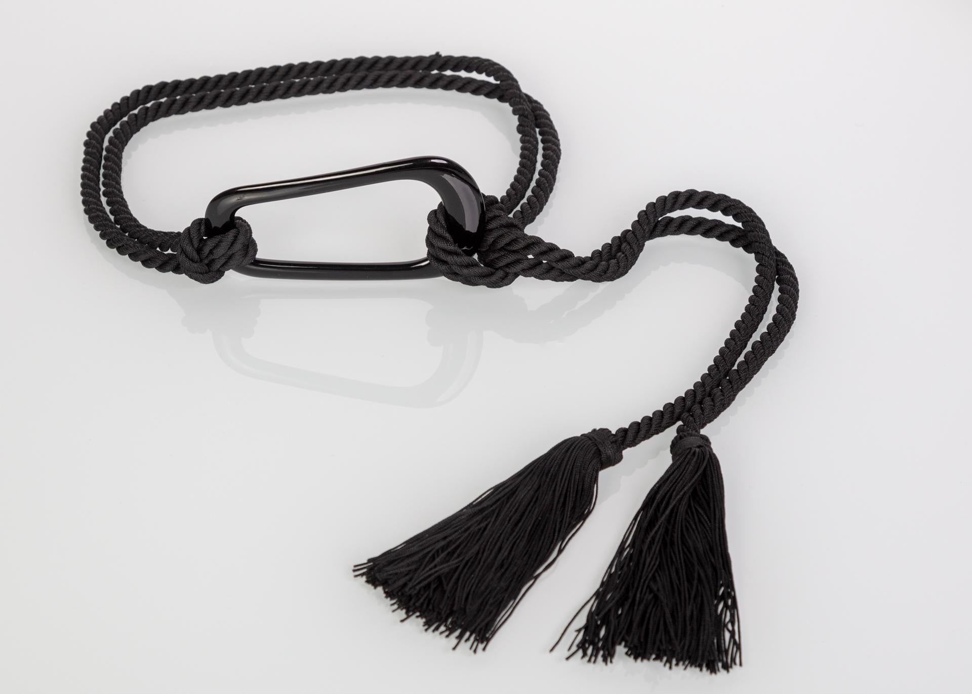 Unlabeled Yves Saint Laurent tassel belt with large plastic buckle.
One size fits all.
