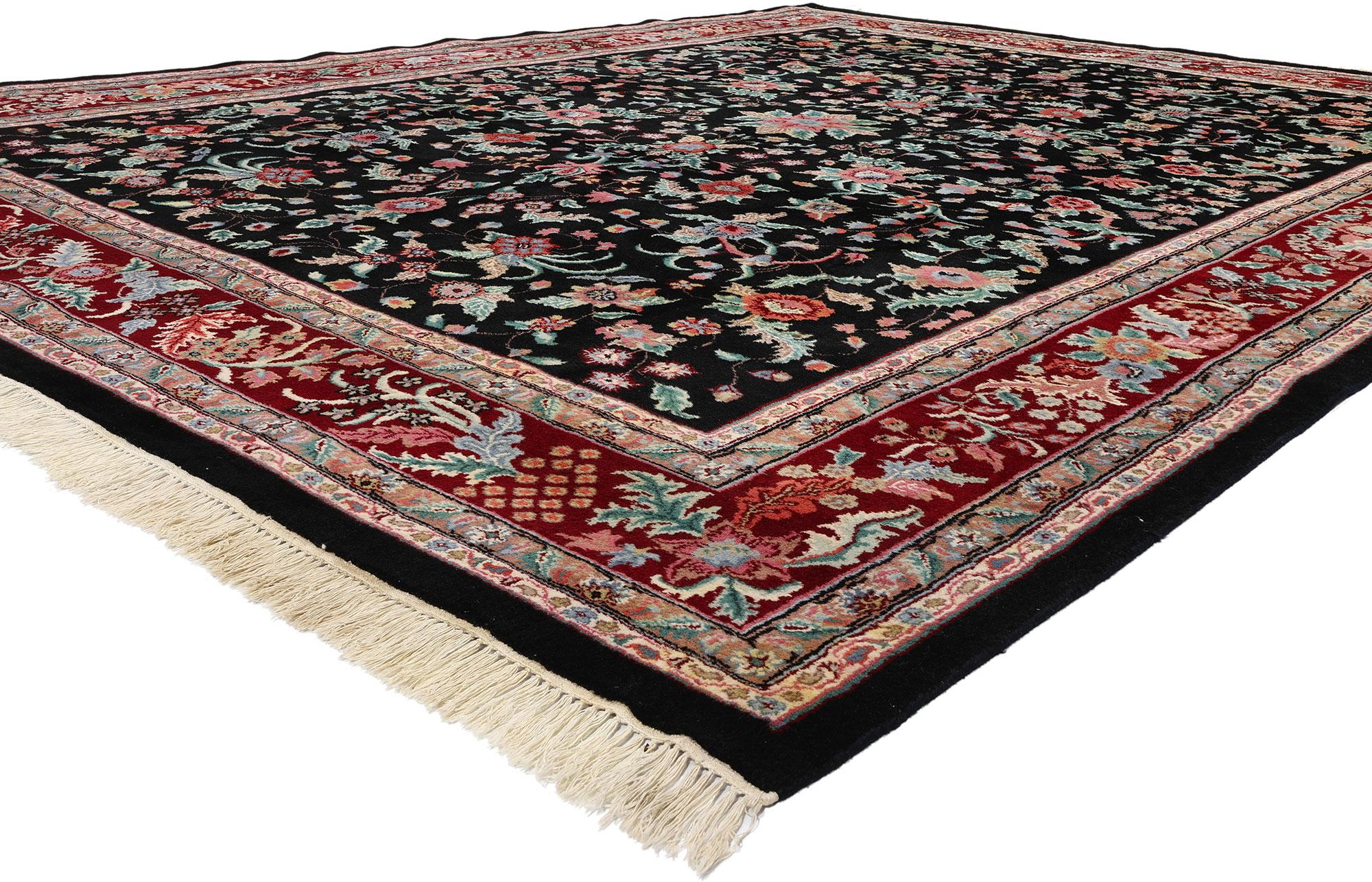 78706 Vintage Black Indian Floral Rug, 09'00 x 12'00. Timeless grace meets classic sophistication in this meticulously hand-knotted wool vintage modern Indian floral rug, unveiling an exquisite narrative of contemporary elegance. Against a beguiling