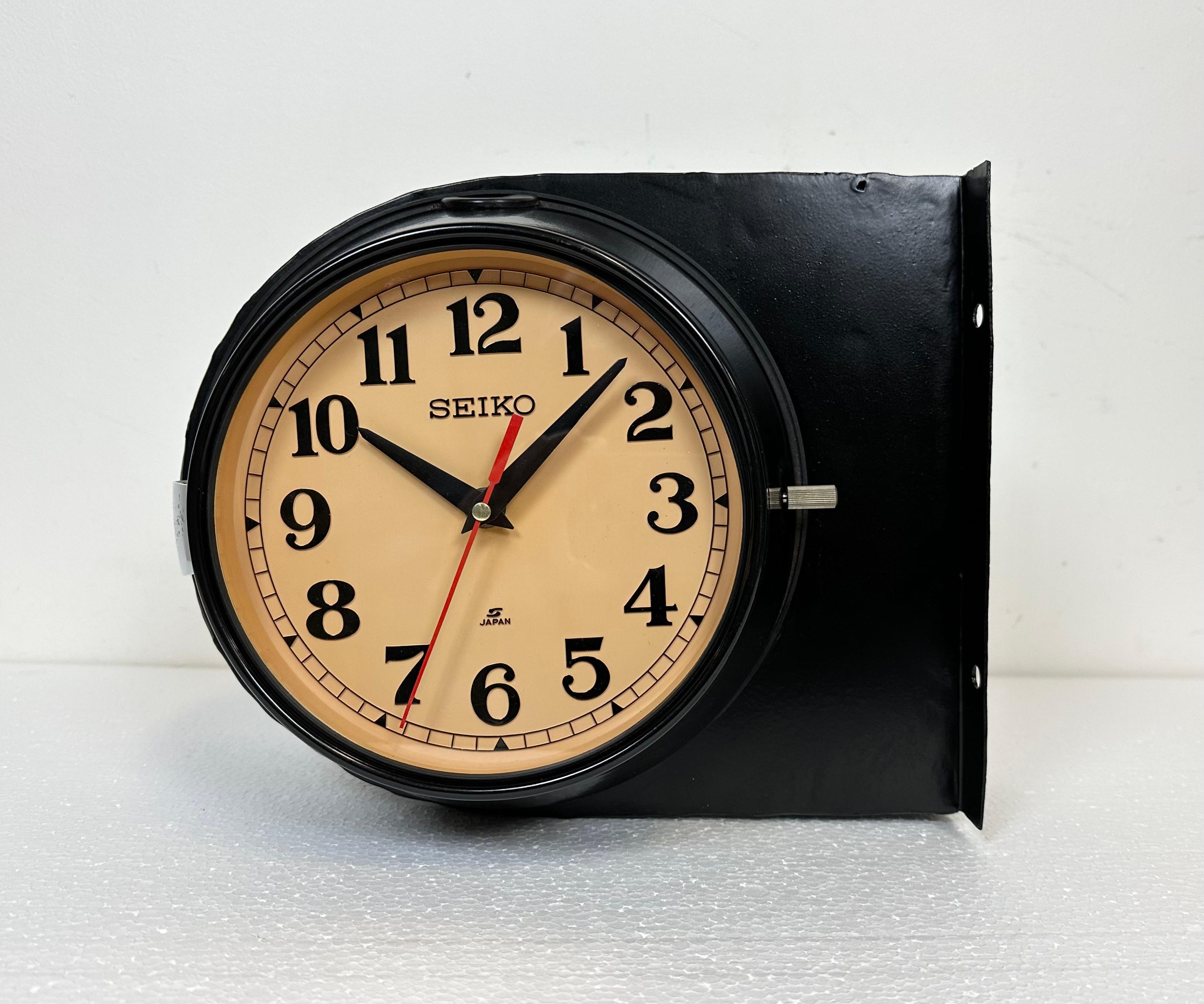 Vintage Seiko navy slave clock designed during the 1980s in Japan. These clocks were used on large Japanese tankers and cargo ships. It features a black metal body, a plastic dials and clear glass covers. This item has been converted into a