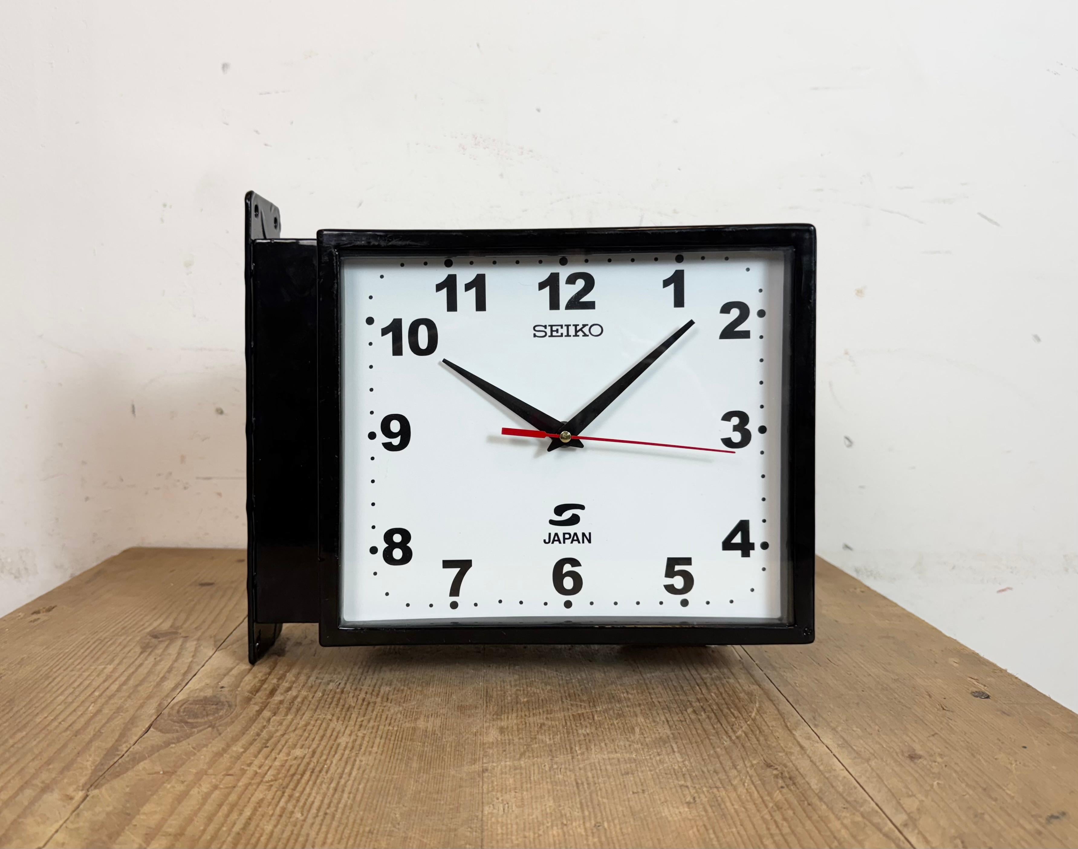 Vintage Industrial rectangular maritime wall clock made by SEIKO in Japan during the 1970s. These clocks were used on large tankers and cargo ships. It features a black metal body, a metal dials and a clear glass covers. Former electric slave clock
