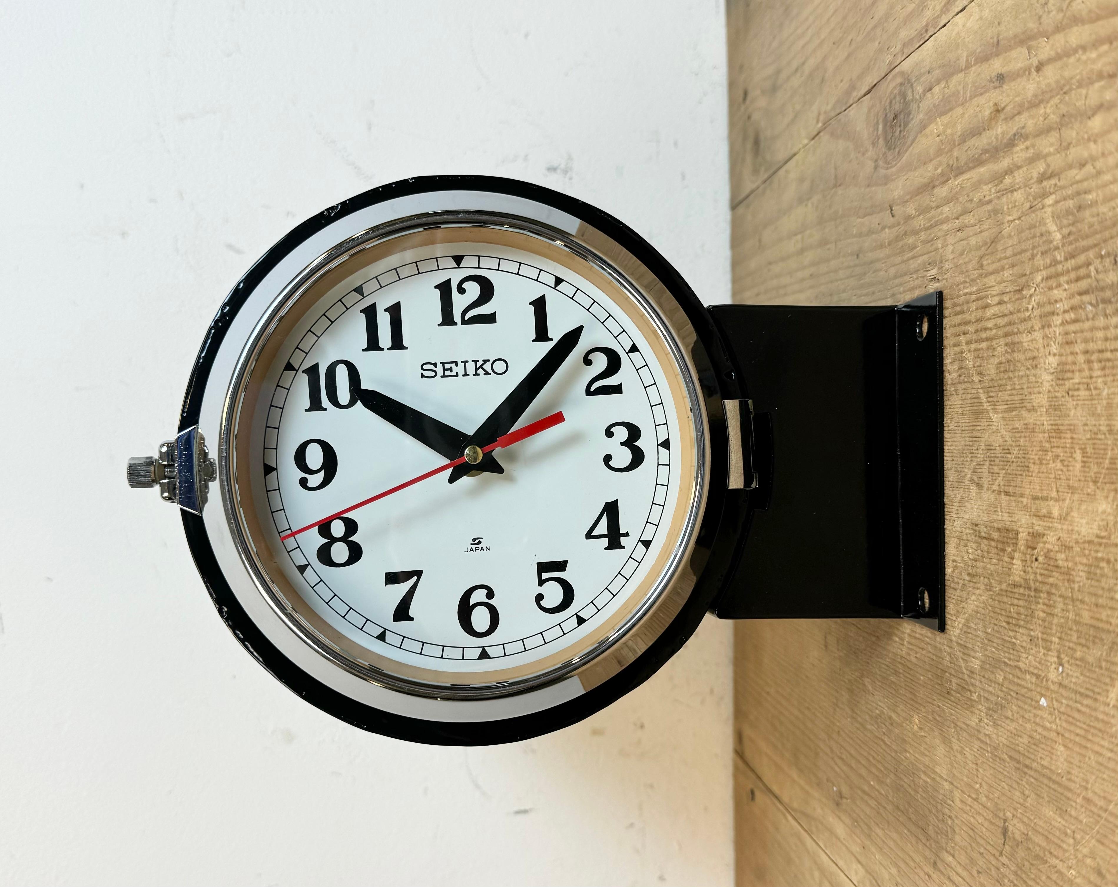 Vintage Industrial Seiko navy slave clock made in Japan during the 1980s. These clocks were used on large tankers and cargo ships. It features a black metal body, a metal dials and a clear glass covers with chrome frames. Former slave clock has been