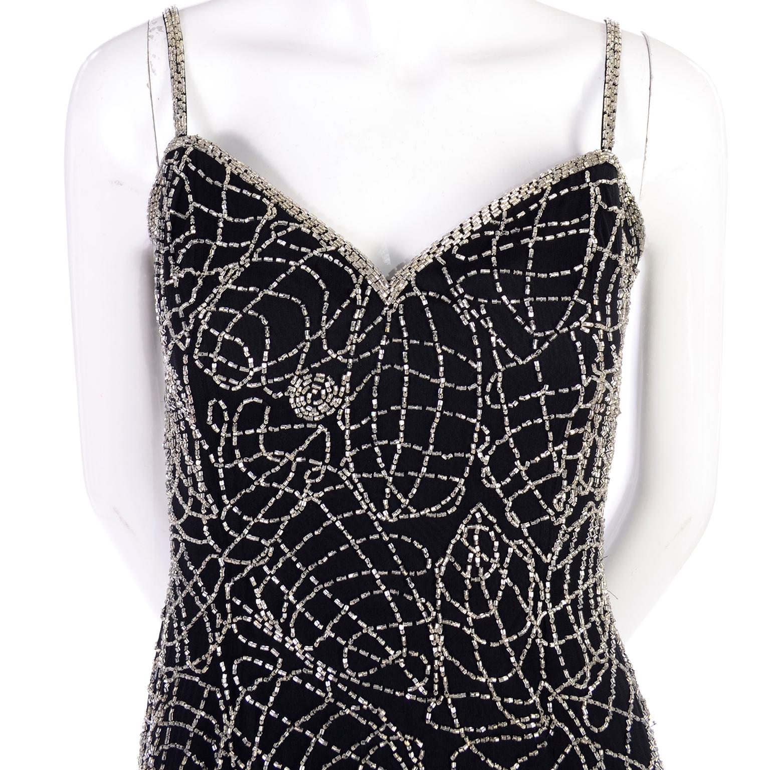 This is a great black silk vintage cocktail dress with abstract silver sparkling swirls of beading. Lined in rayon, this fitted dress has built-in boning in the bustier. Marked as a 6, but measures more like a US size 4. 