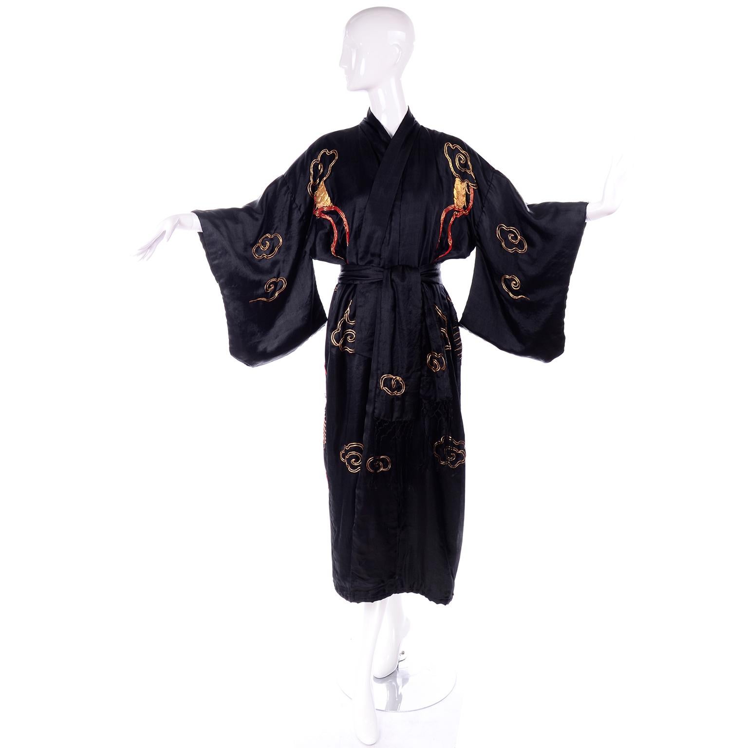 This is an incredible Japanese vintage embroidered kimono with a Chinese dragon design! This long kimono is made of a padded black silk, with thick metallic embroidery depicting dragons, clouds and lightning bolts. The thick metallic gold and red
