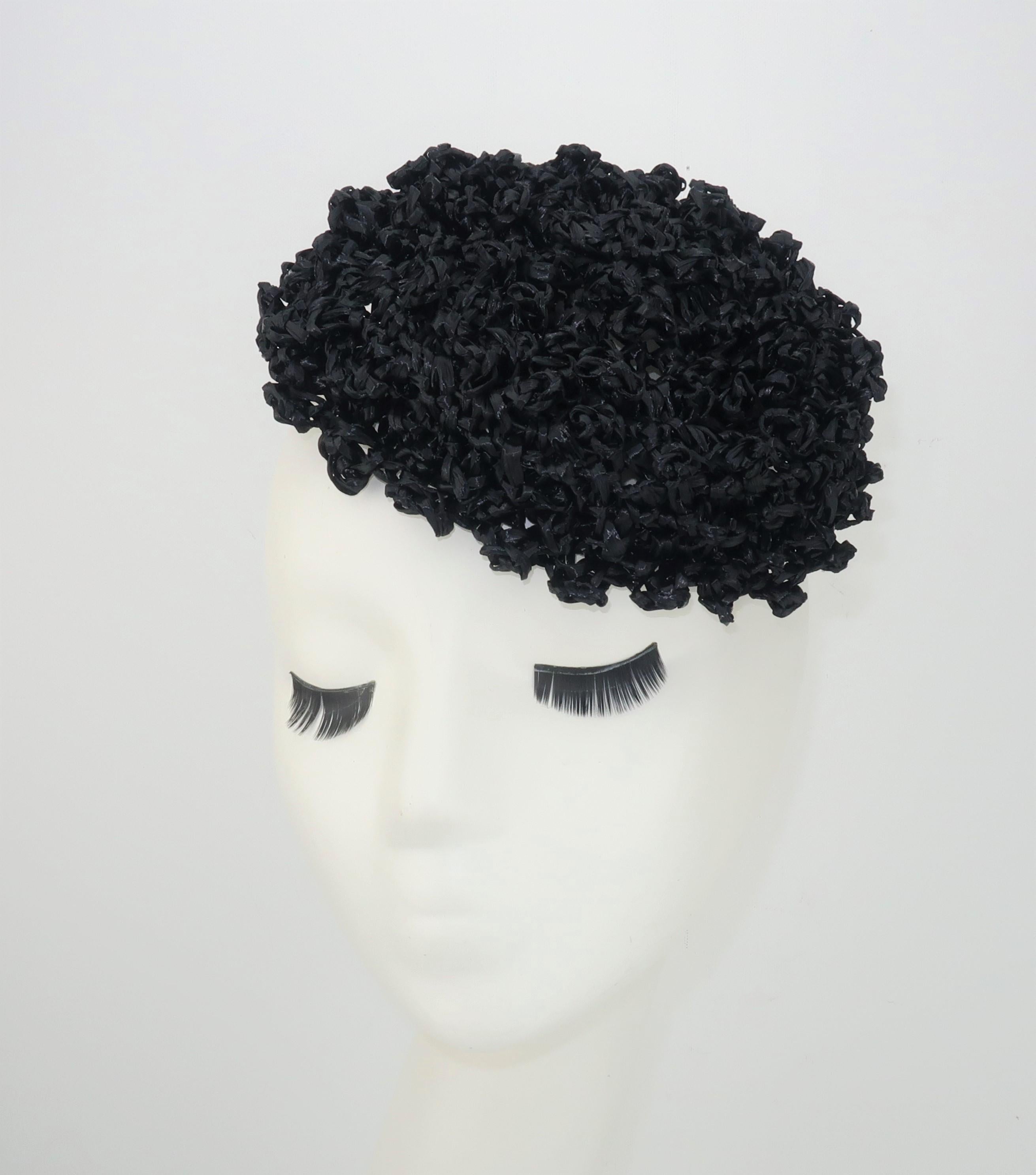 Vintage black straw curlicue fascinator style hat with two small combs stitched at the inner rim for anchoring in place.  No manufacturer's label present ... good vintage condition.  From the living estate of an amazing fashionista who was born in