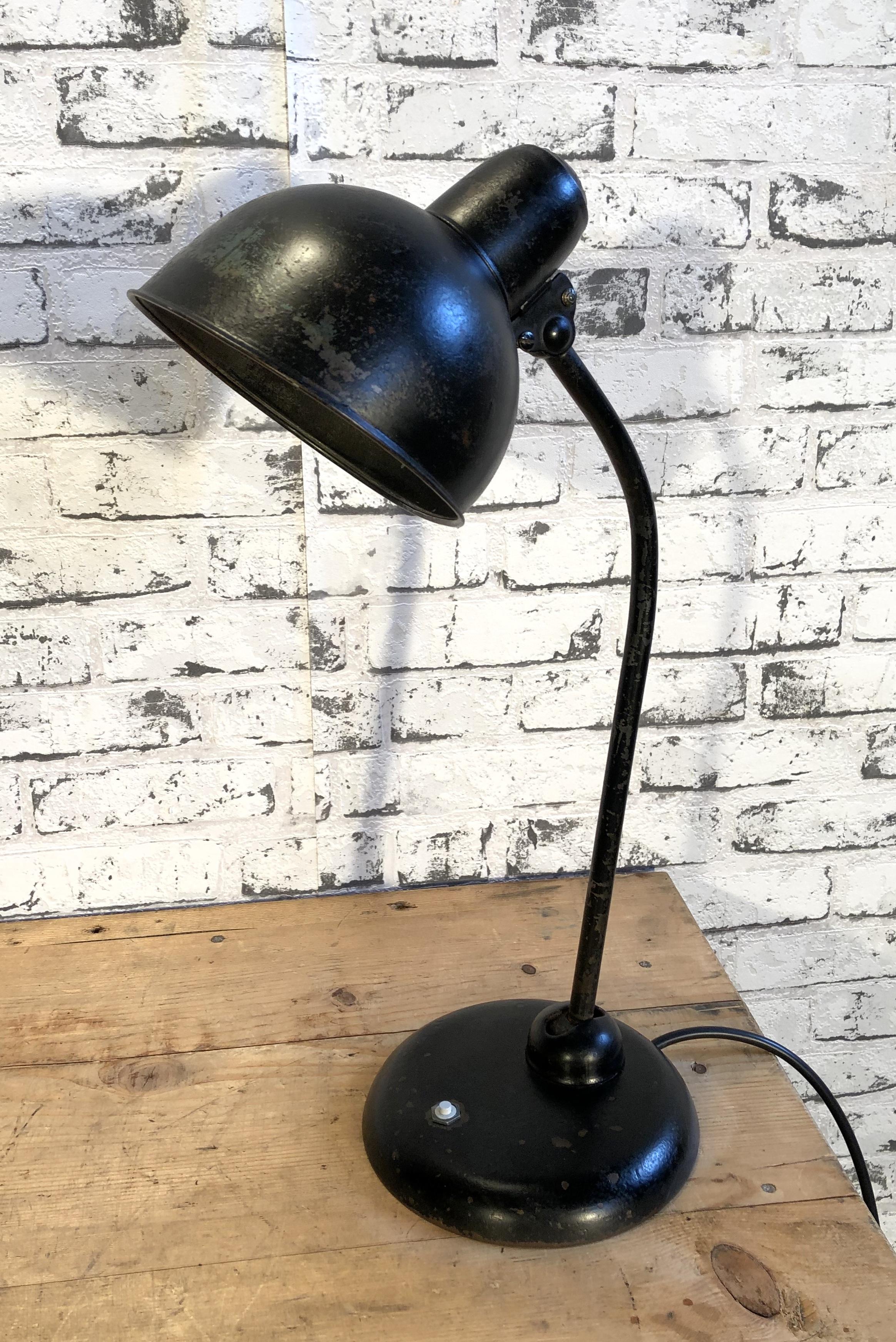 This industrial Bauhaus table lamp was designed by Christian Dell and produced by Kaiser Idell in Germany during the 1930s. The lamp has two adjustable joints and a socket for E 27 lightbulbs. Good vintage condition.