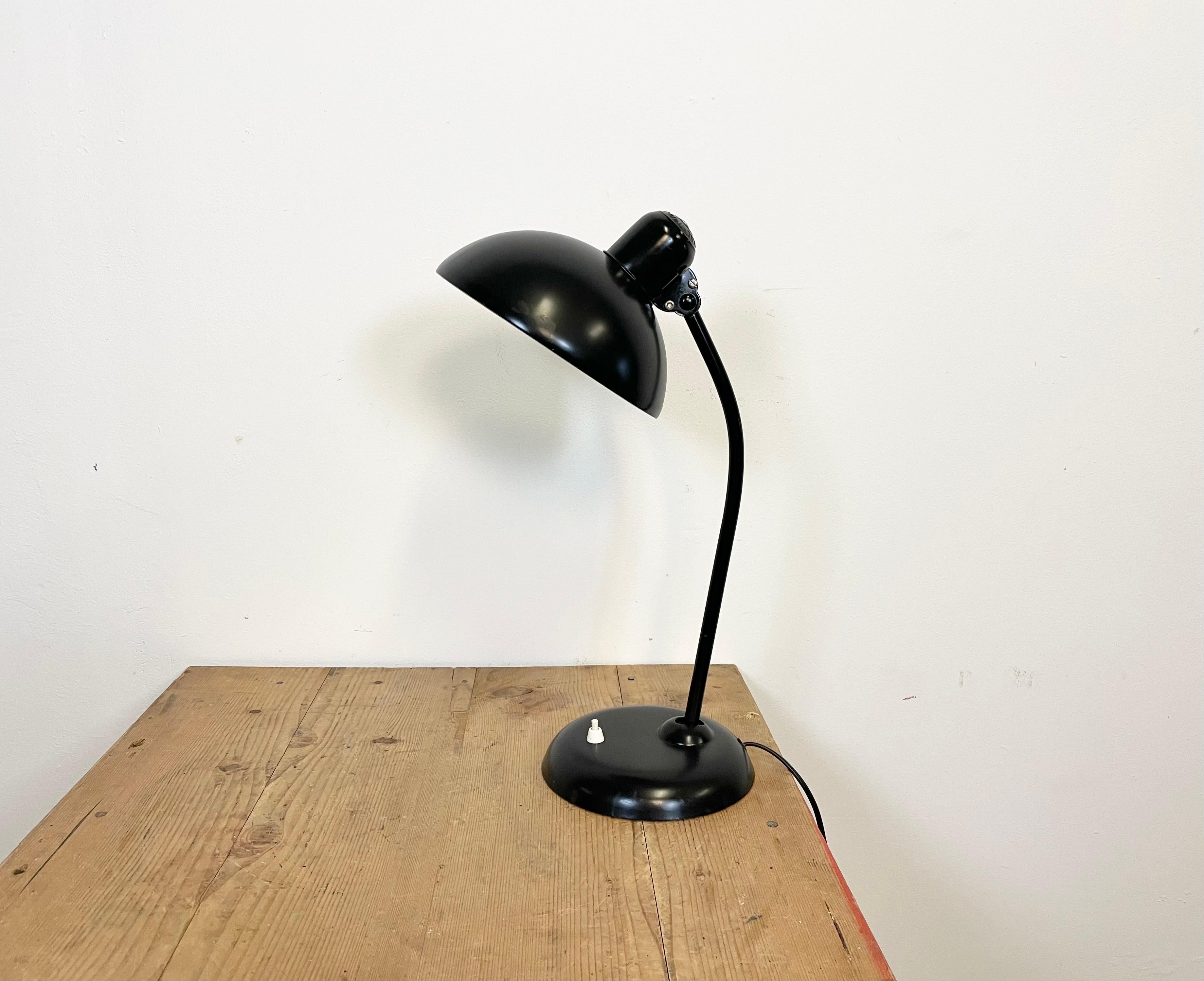Original Bauhaus desk lamp, designed by Christian Dell and produced by Kaiser Idell / Kaiser Leuchten (Germany) during the 1930s.Black metal lamp with adjustable arm and shade. The lamp has the ''traditional'' embossed shade with ''Original