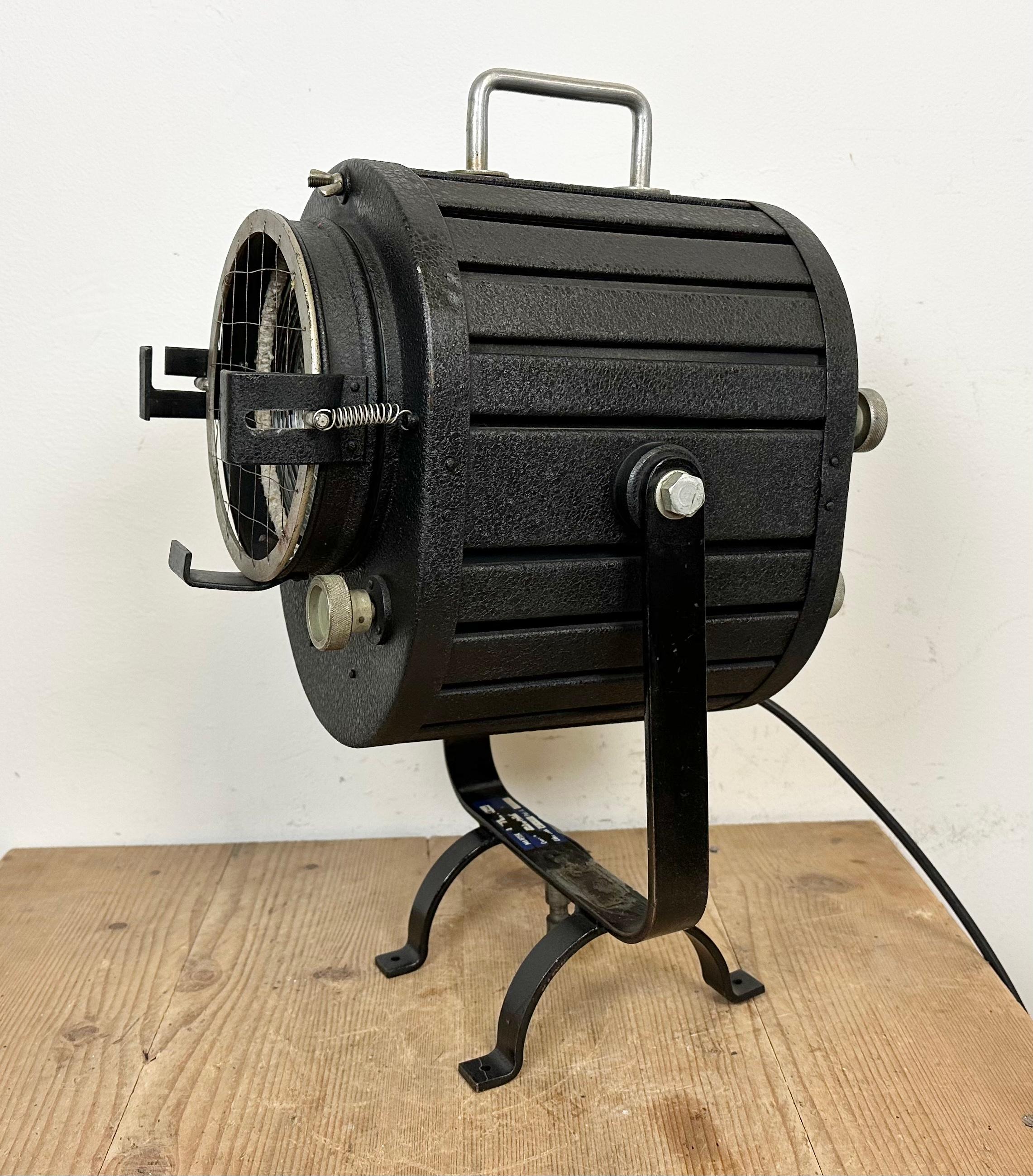 - Vintage theatre spotlight table lamp made in former Czechoslovakia during the 1960s 
- It features a black metal body and a glass lens cover
- Adjustable angle
- The porcelain socket requires E27/ E26 lightbulbs 
- New wire
- The weight of the