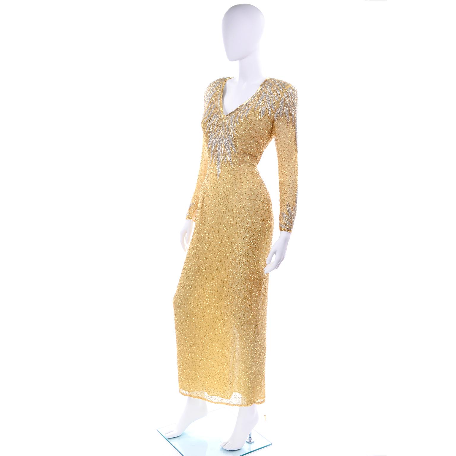 This is a stunning vintage gold silk beaded Black Tie evening dress from the 1980's.  This incredible long dress is covered in silver and gold bugle beads and is so beautiful in person! There are shoulder pads for structure, a slit up the back and a