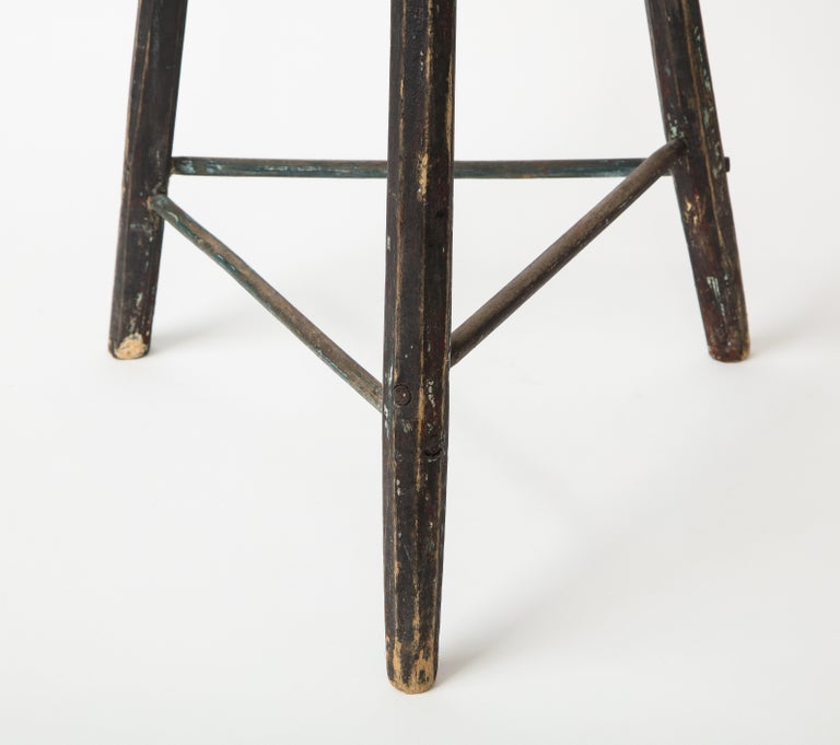 Vintage Black Tripod Stool with Rustic Wood Top. 

Handsome design consists of three faceted legs, staggered crossbars, and a rough, rustic wood seat top. This versatile piece can variably function as a stool, side table, or stand.