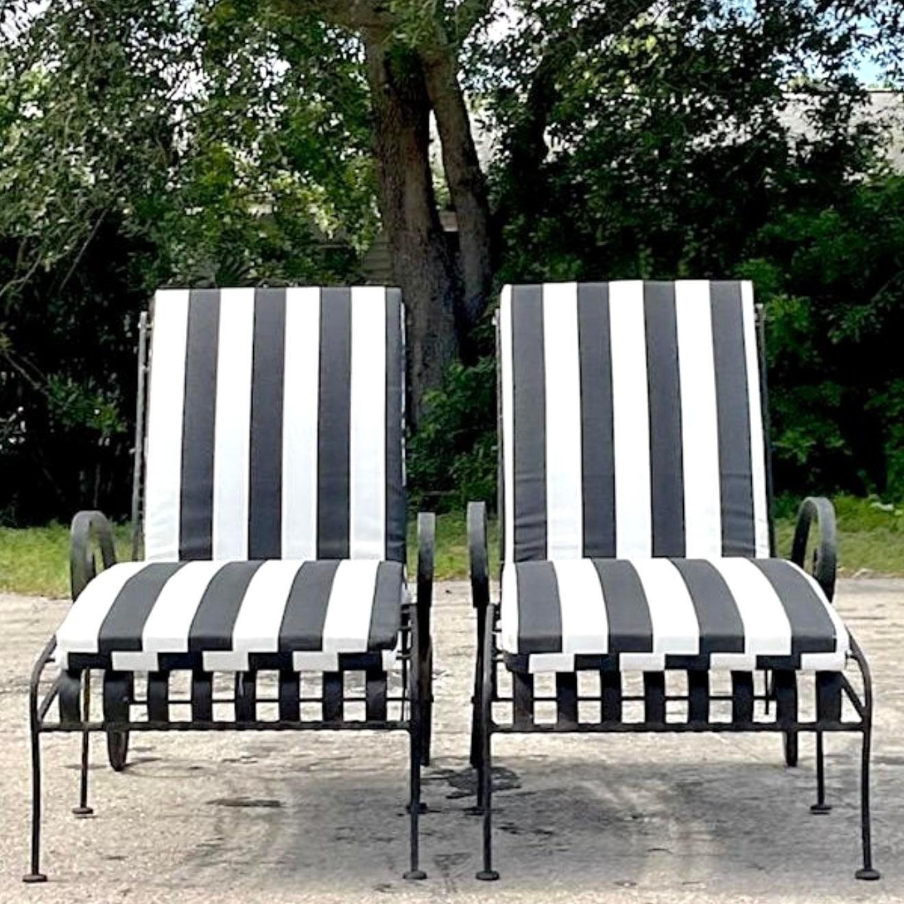 A fabulous pair of vintage Coastal chaise lounge chairs. Beautiful slat wrought iron design with adjustable back. Chic cabana striped cushions. Two sets available on my  page. Acquired from a Palm Beach estate.