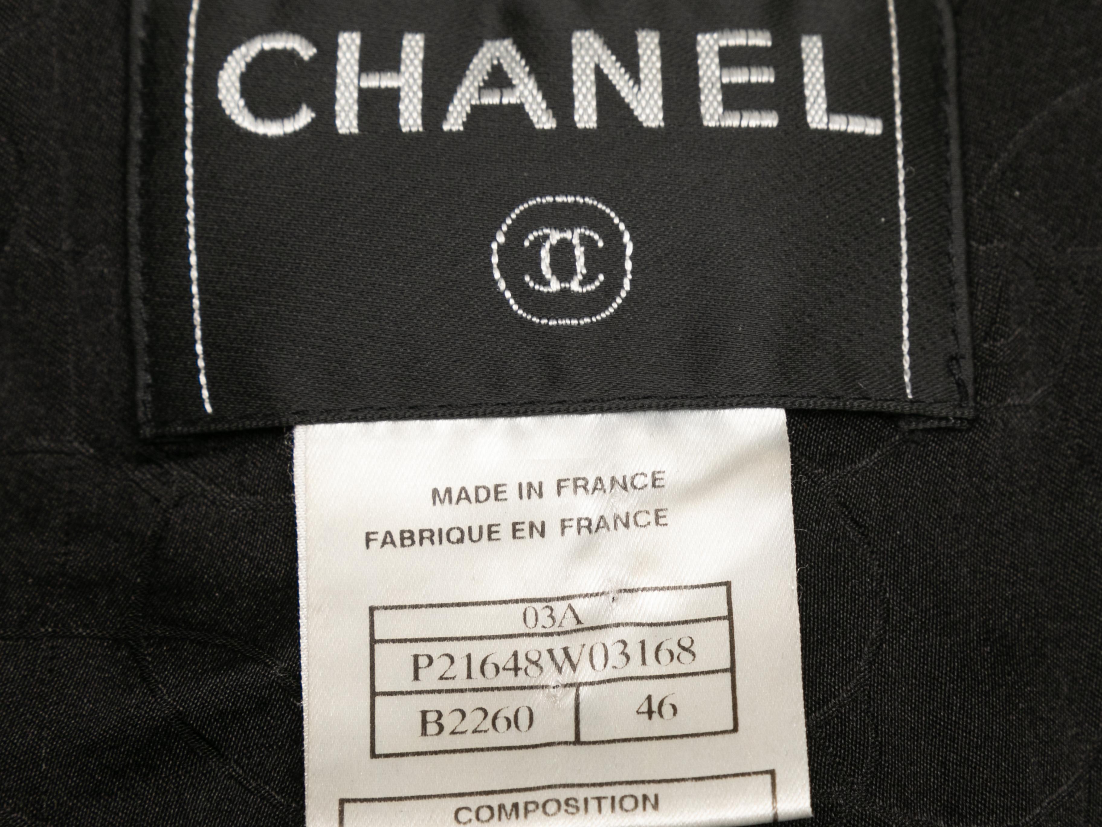 Vintage black and white tweed blazer by Chanel. From the Fall/Winter 2003 Collection. Purple piping throughout. Notched lapel. Four front pockets. Front button closures. 36