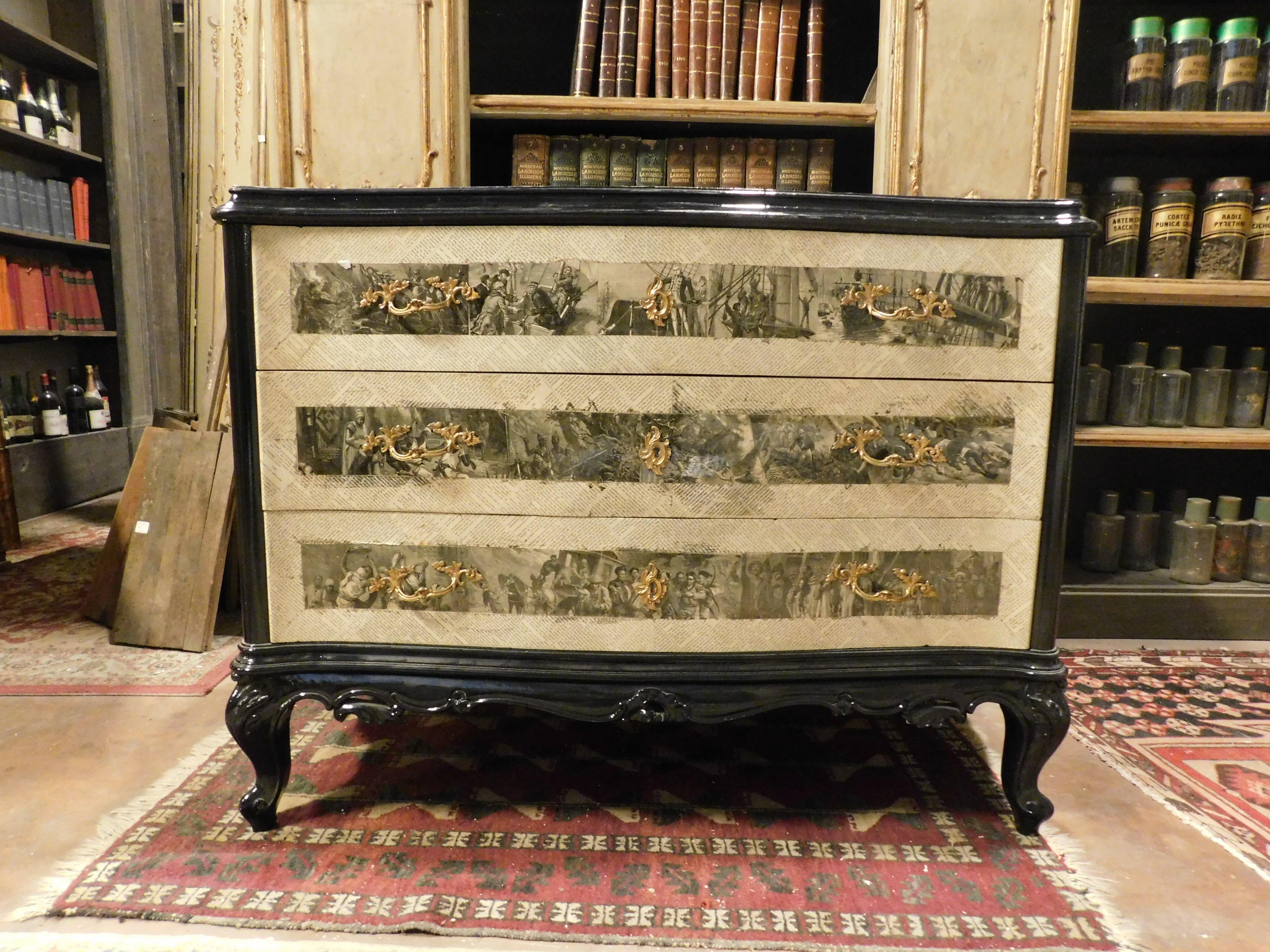 Vintage dresser in black ebonized wood, covered in French newspaper paper and prints depicting historical hunting scenes, gilded bronze applications and handles, 3 wavy drawers, built and decorated in the 20th century in France, maximum size cm w