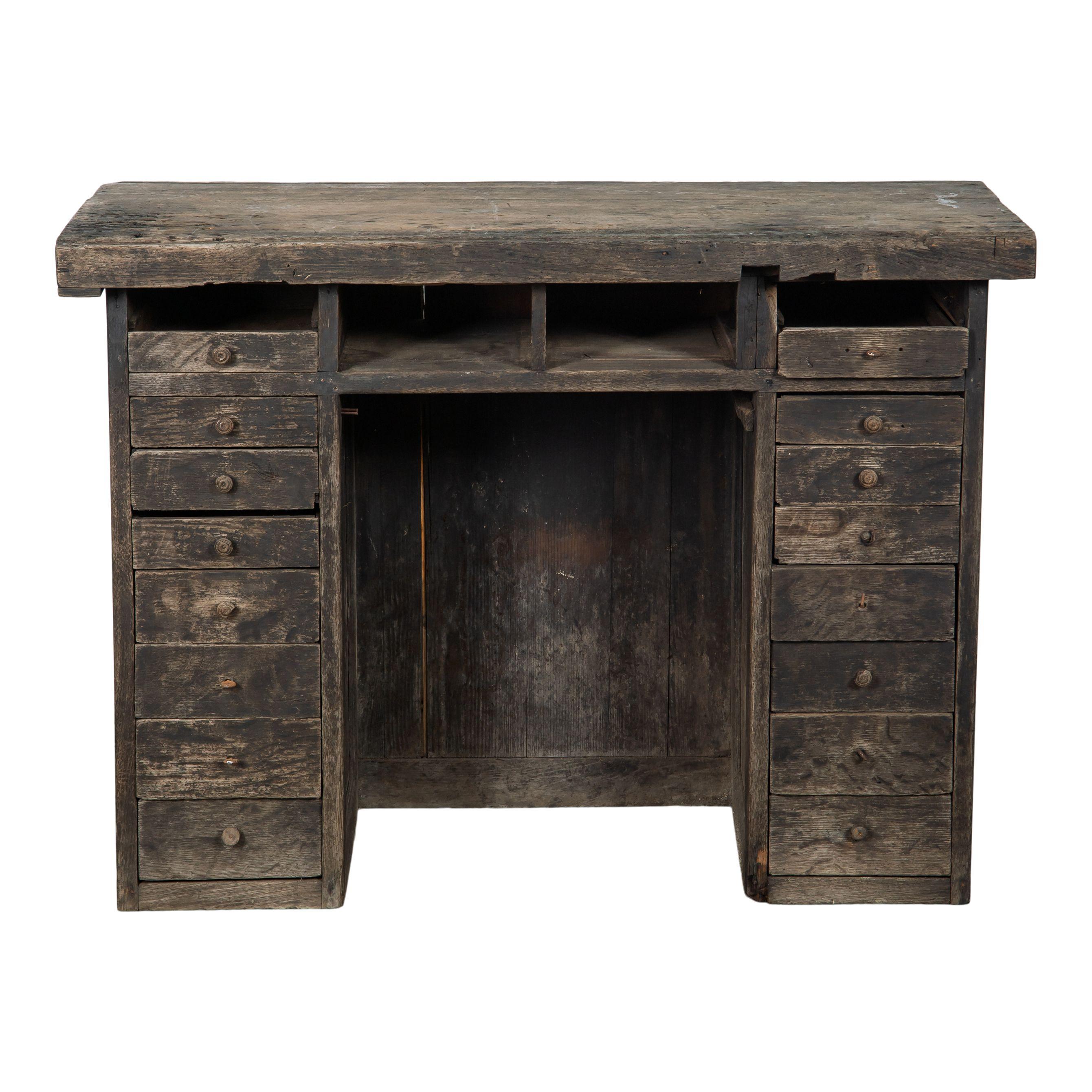 A classic vintage wood desk with drawers and storage space. There are 8 drawers on each side, each with a small round pull, and four open storage spaces right under the tabletop. The middle has space for a chair and the back side features lovely