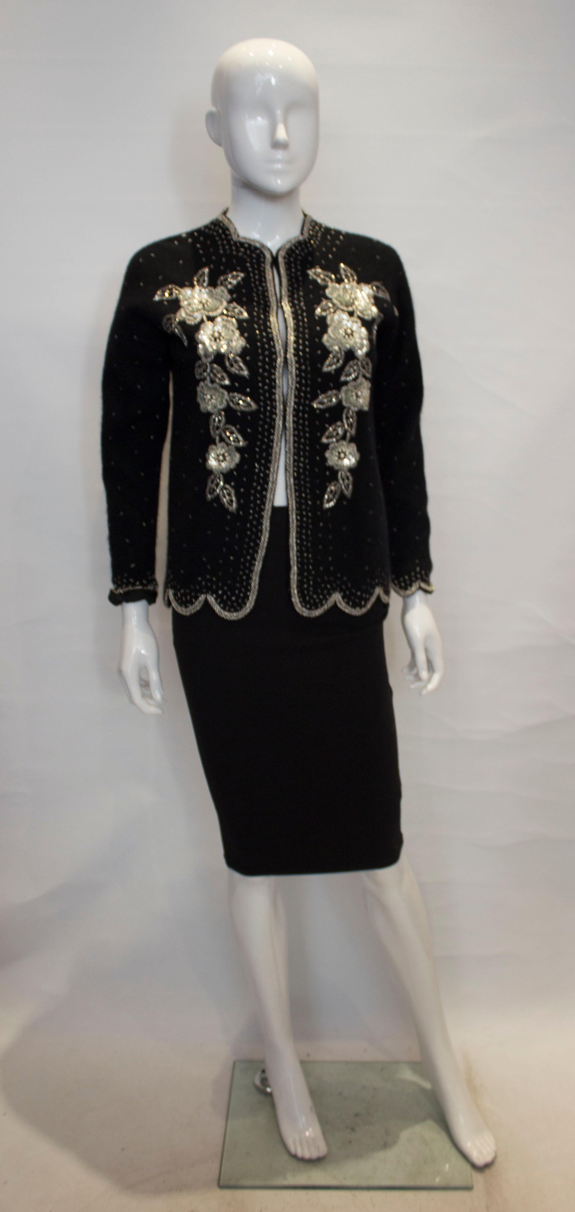 A wonderful vintage addition to your party wardrobe . This wool cardigan is fully lined , with wonderful embellishment and an attractive scallop hemline. It fastens with hooks and eyes.