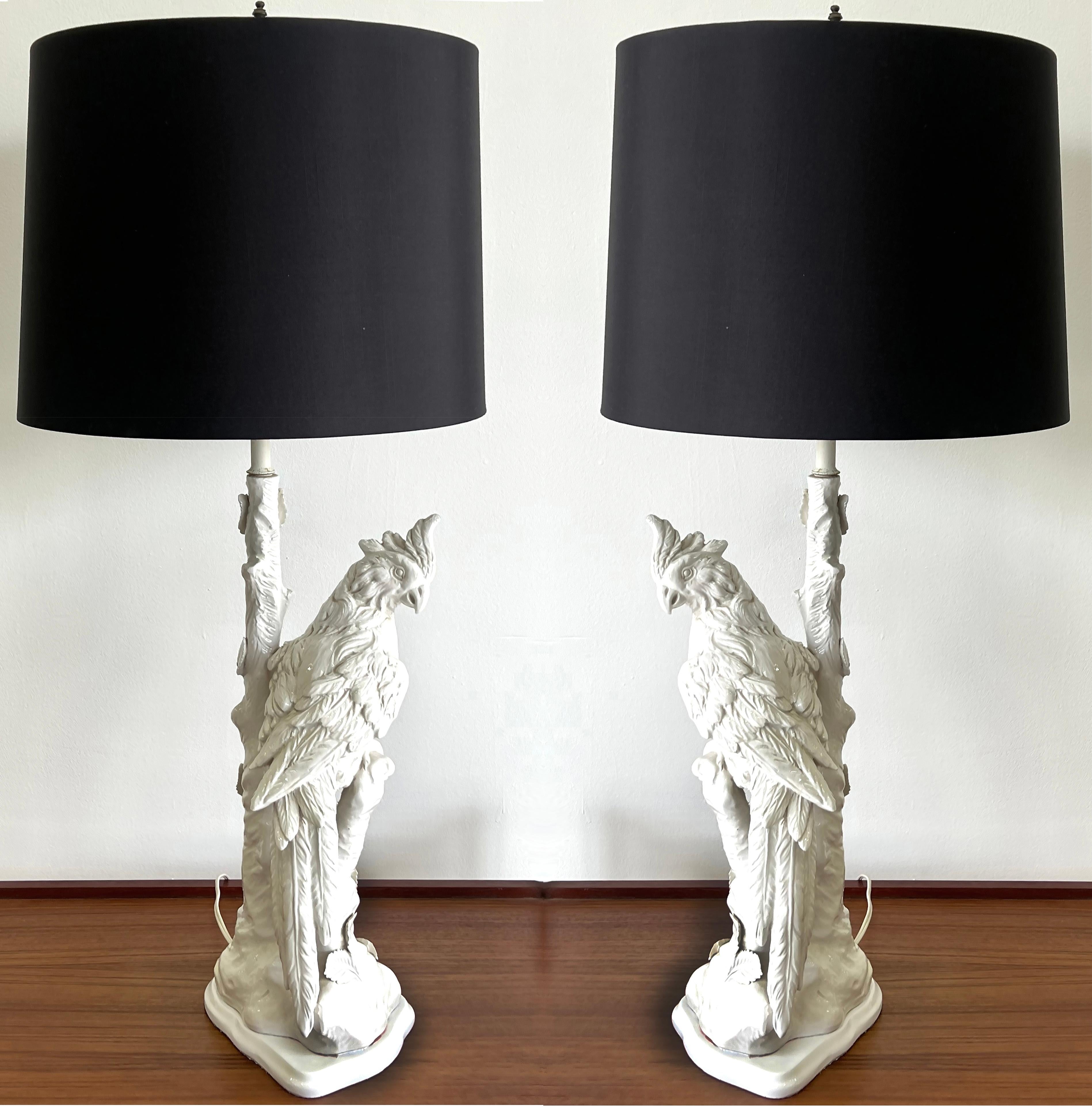 Offered for sale is a pair of vintage Blanc De Chine bird motif ceramic lamps.  The lamps have a  parrot or cockatiel perched in a tree with foliage. The figures are nicely detailed The lamps are a true pair with a left-facing and a right-facing