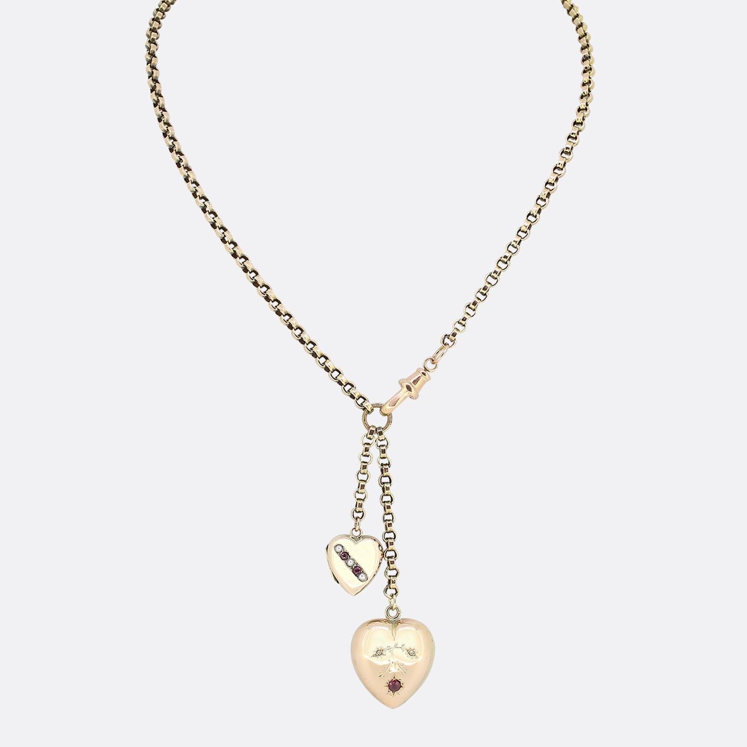 This is a vintage 9ct yellow gold belcher charm necklace. The necklace has two charms suspended from the chain including a ruby and pearl heart along with a diamond and ruby heart. The necklace is secured by an antique swivel clasp.

Condition: Used